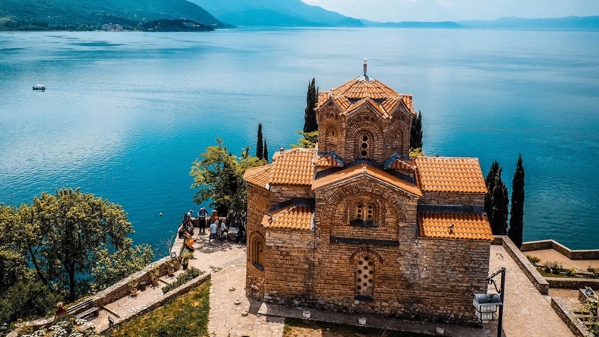 a church on a hill overlooking a body of water