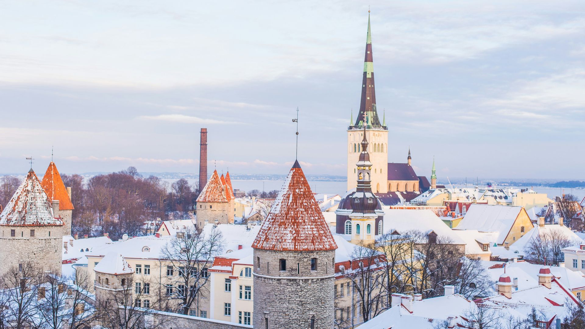 snow covered brown, white, and gray concrete castle under cloudy skies