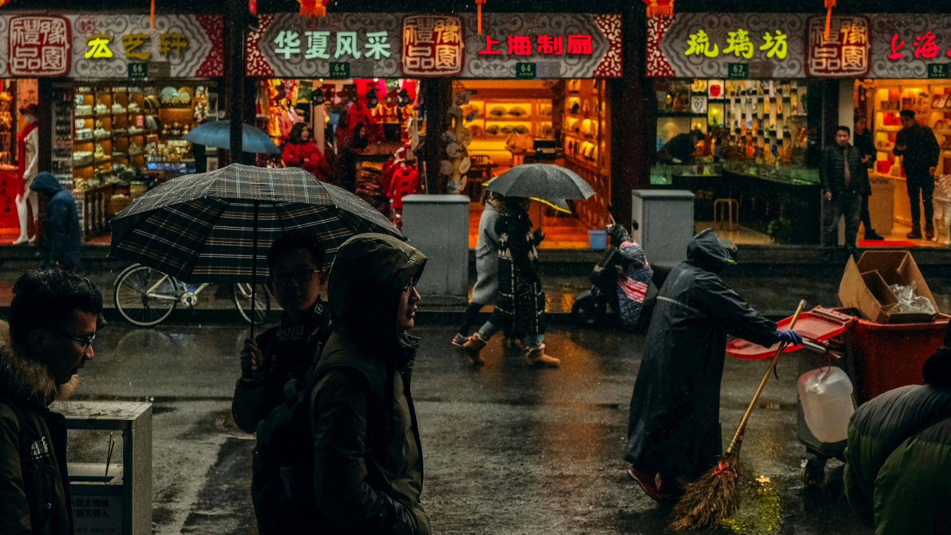 person carrying umbrellas