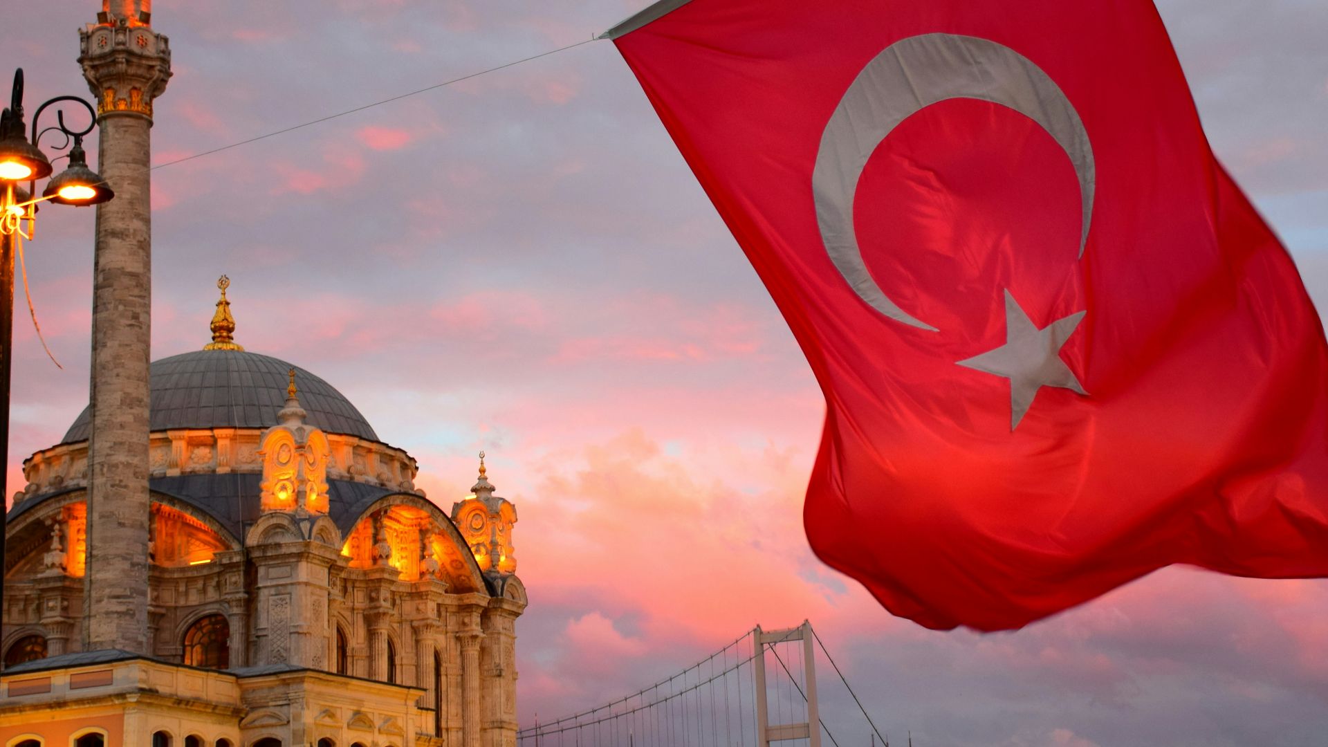 red flag on top of brown concrete building during daytime