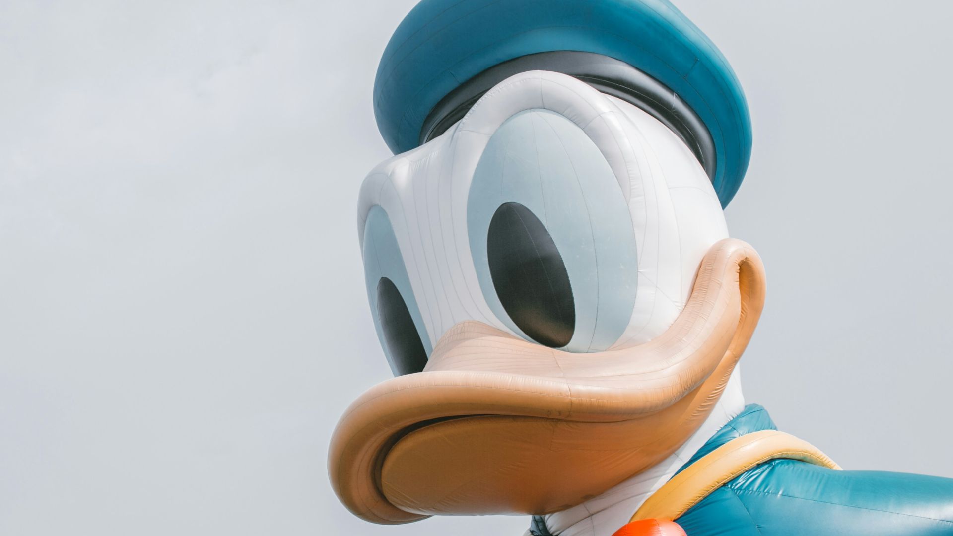 a large mickey mouse balloon with a bow tie