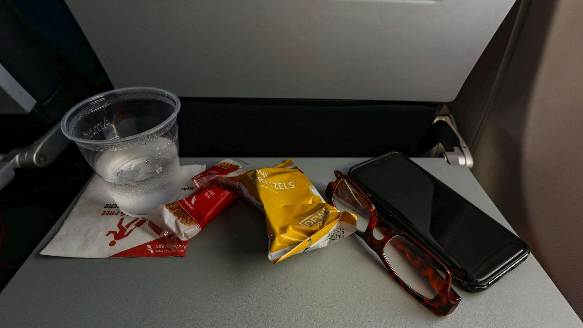 a table with a cell phone and some snacks on it