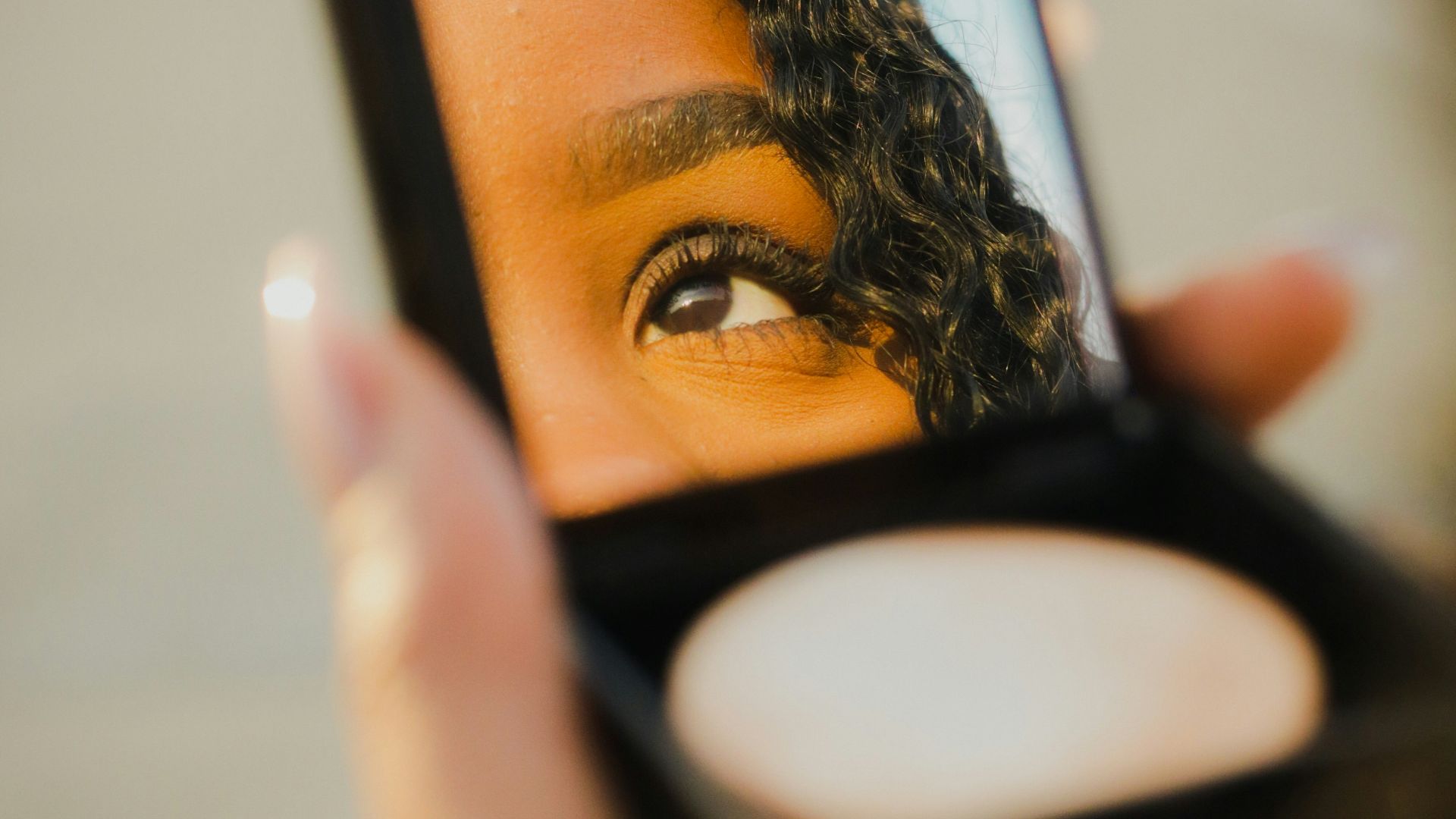 a woman holding a compact compact compact compact compact compact compact compact compact compact compact compact
