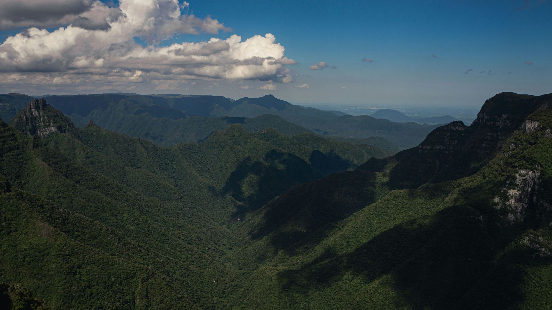 a scenic view of a mountain range with clouds in the sky