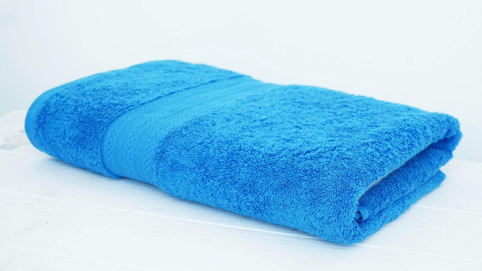 a blue towel sitting on top of a white table
