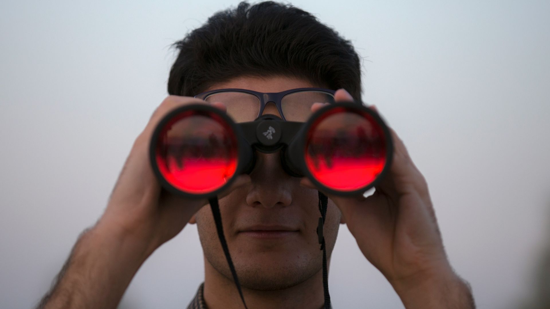 person holding black binoculars