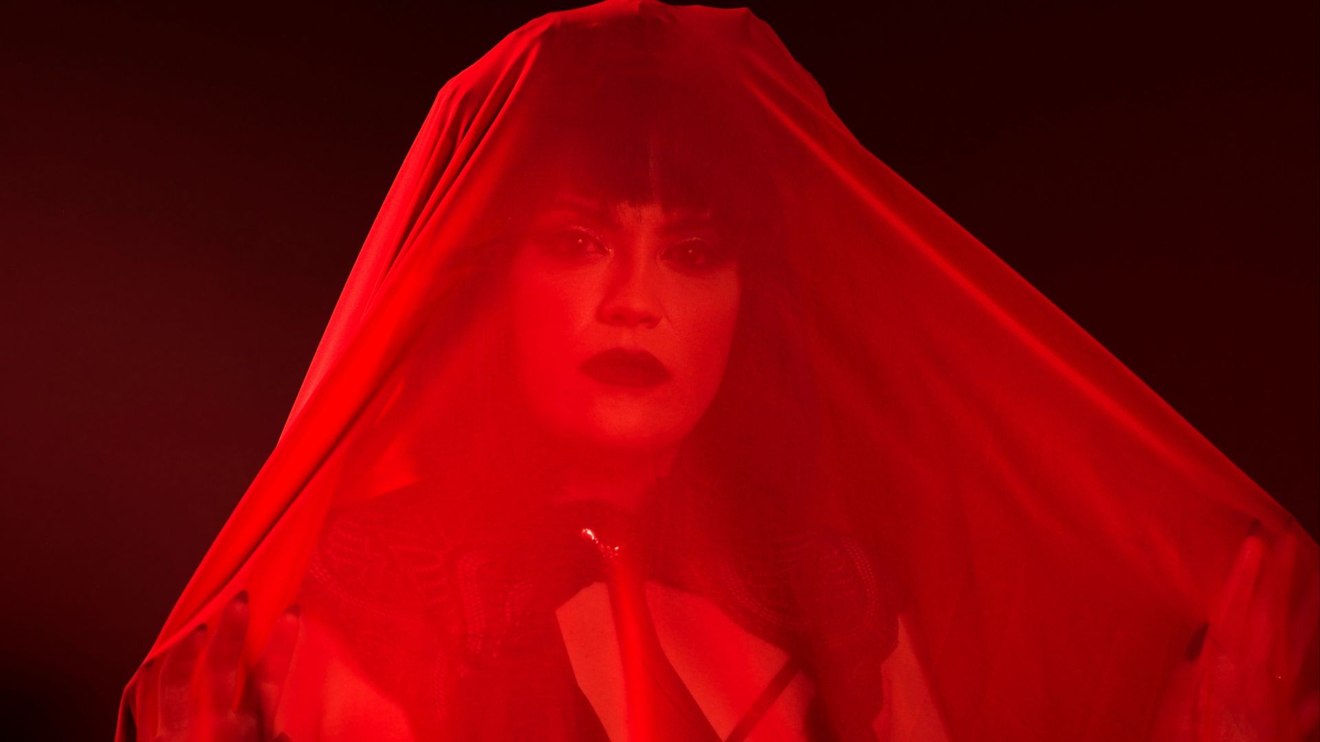 red robe on white plastic clothes hanger