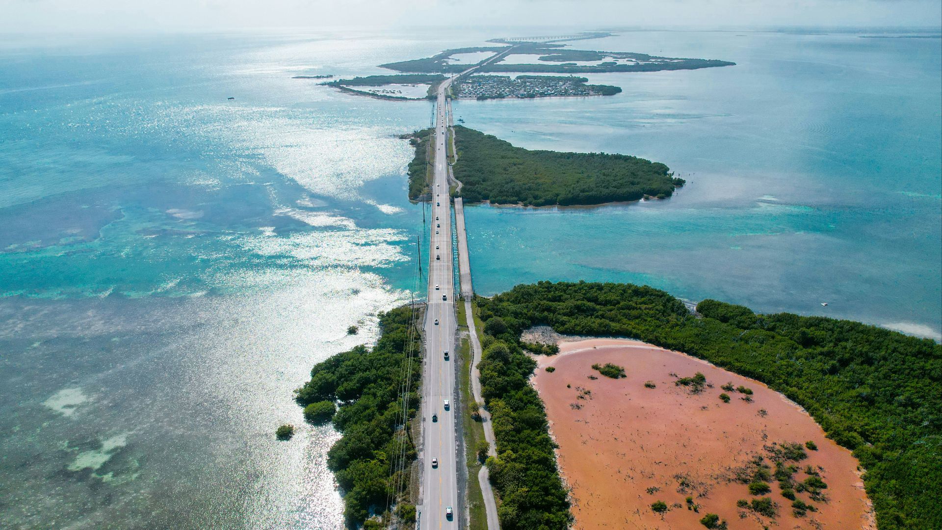 An aerial view of a highway and the ocean