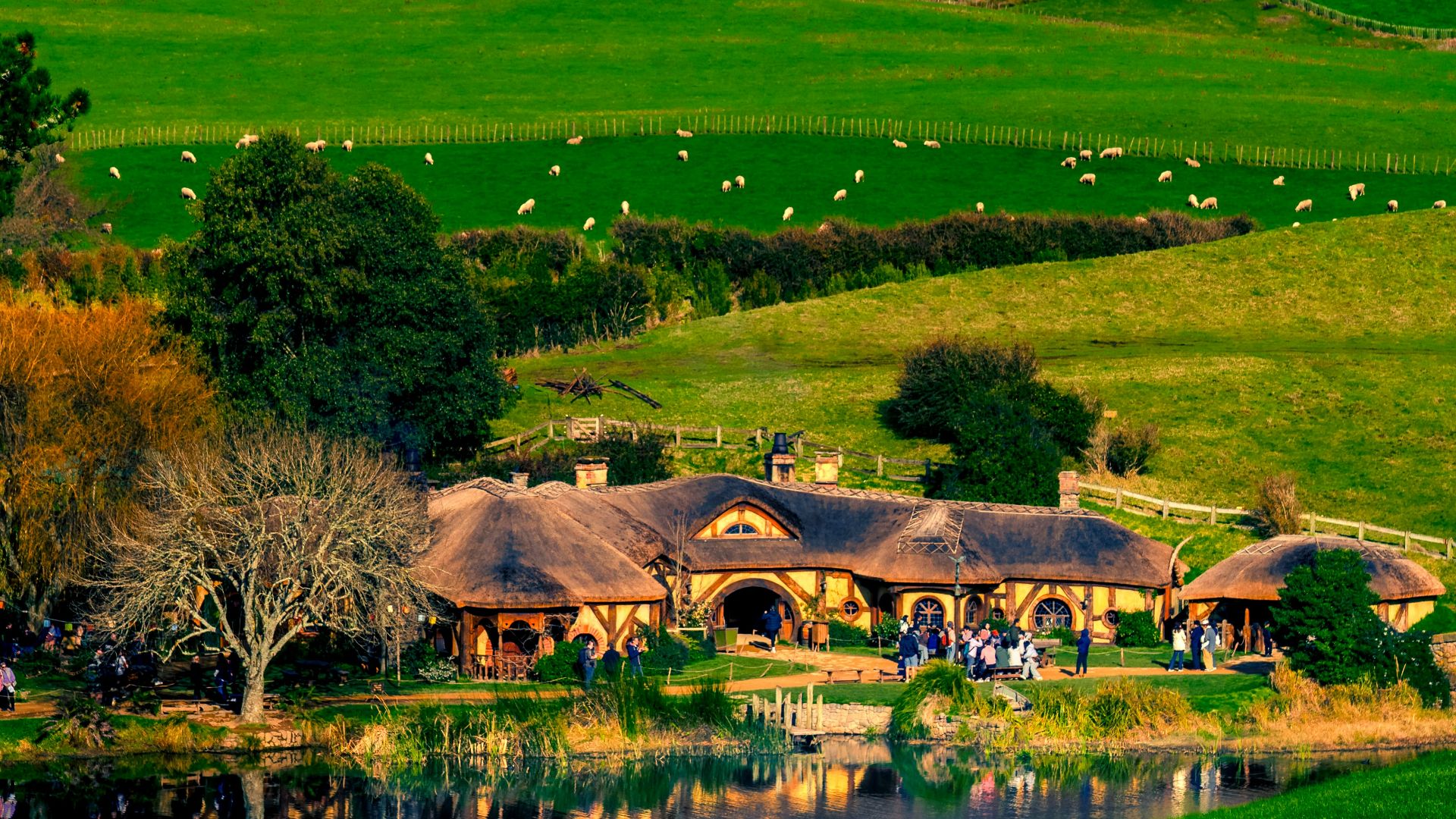 A lush green hillside with a river running through it