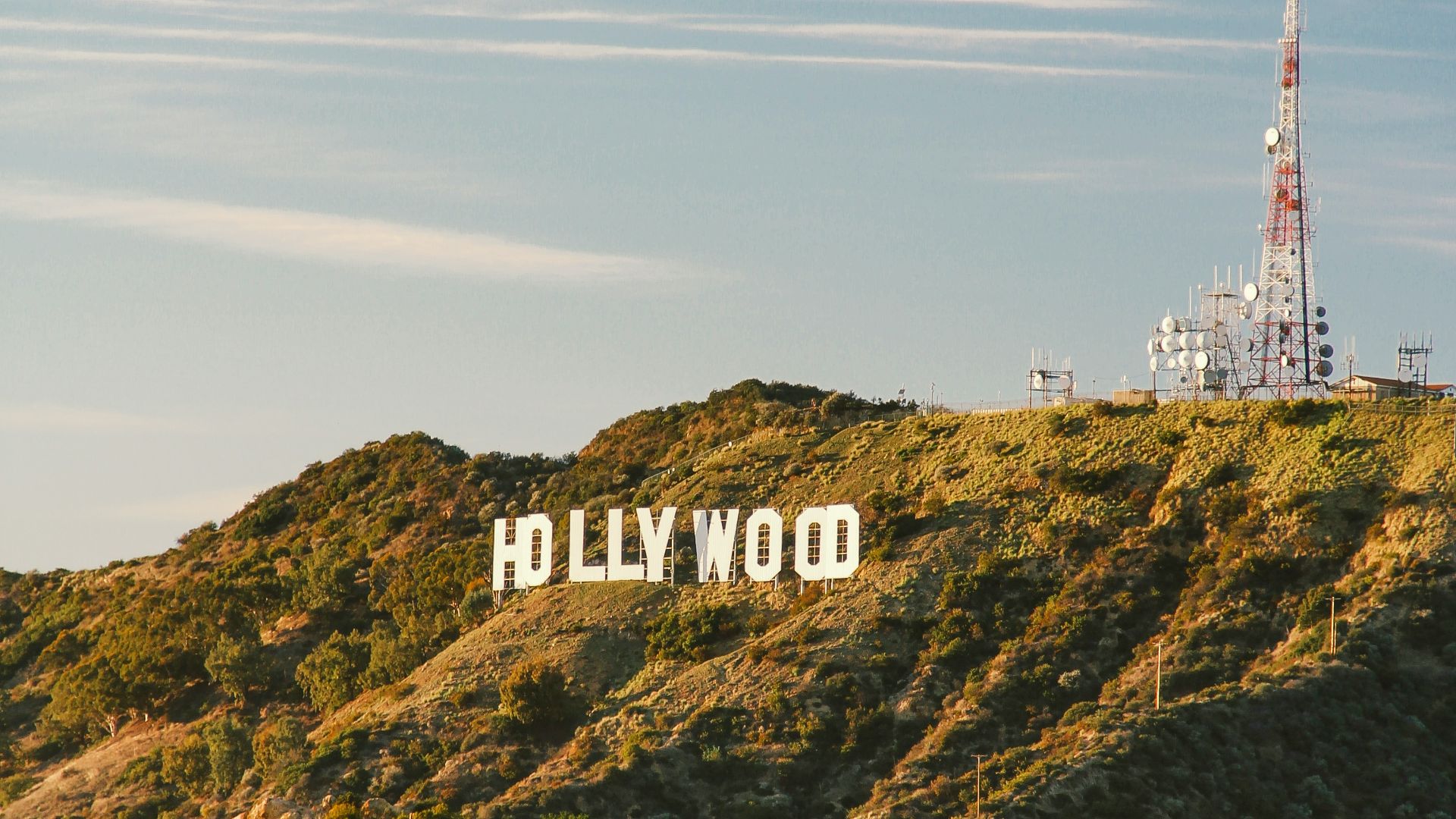 white and red tower on top of green mountain