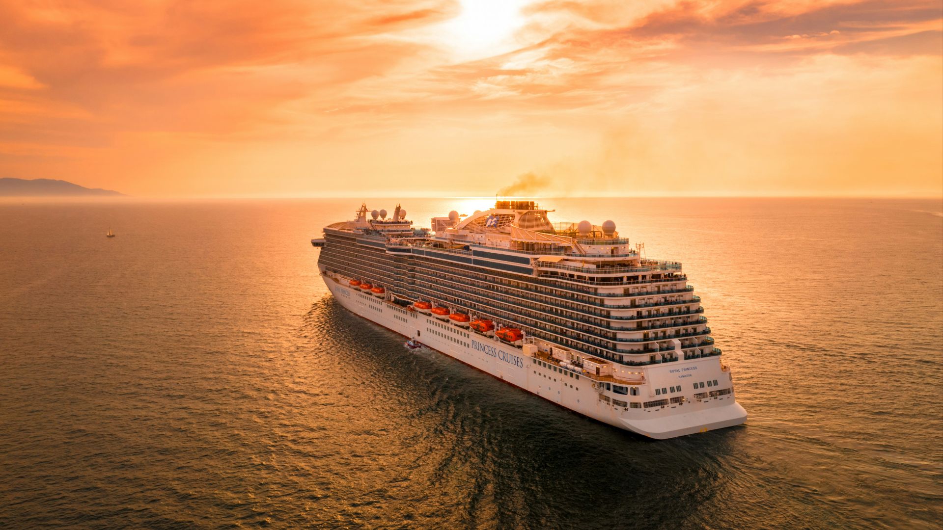 white ship on sea during sunset