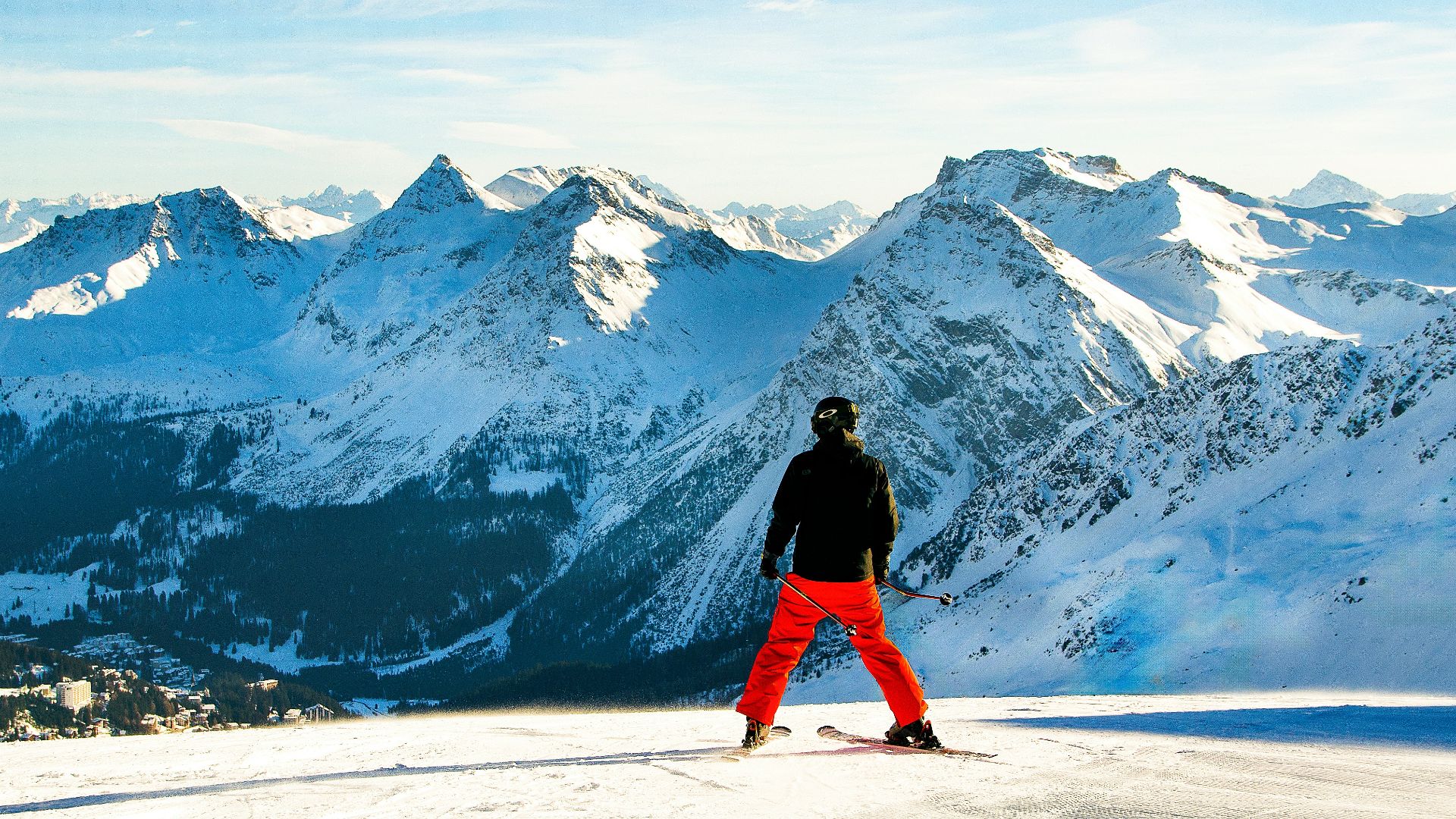 a man standing on top of a snow covered slope