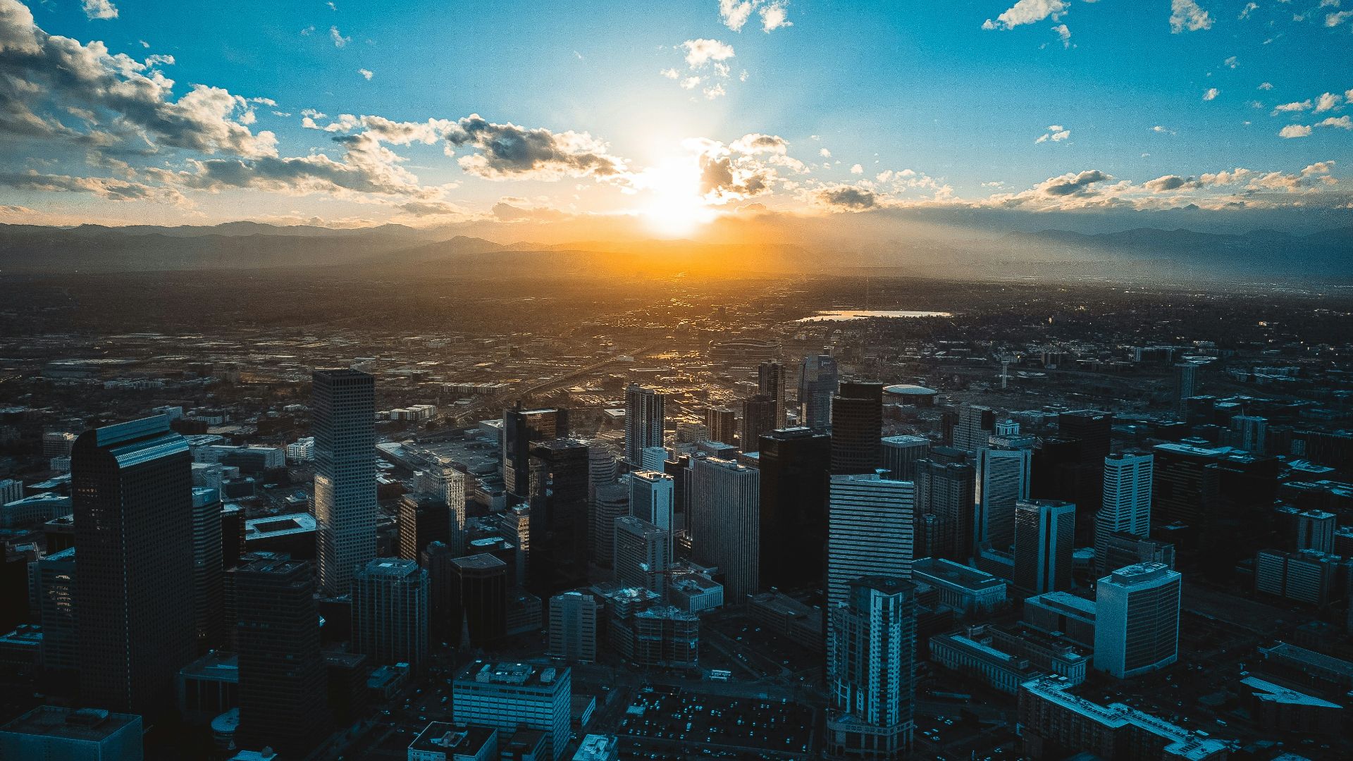 the sun is setting over a large city