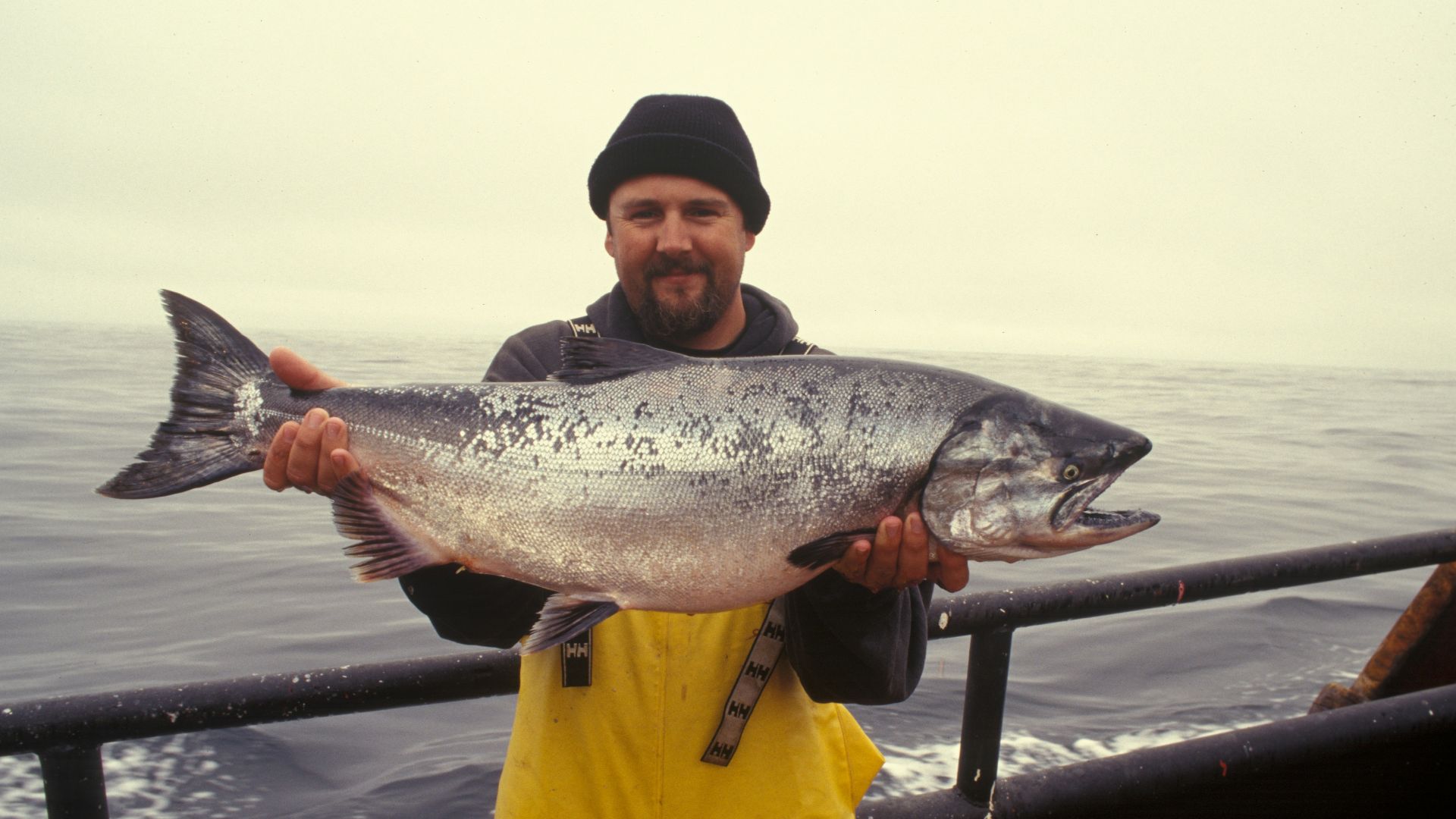 man carrying silver fish