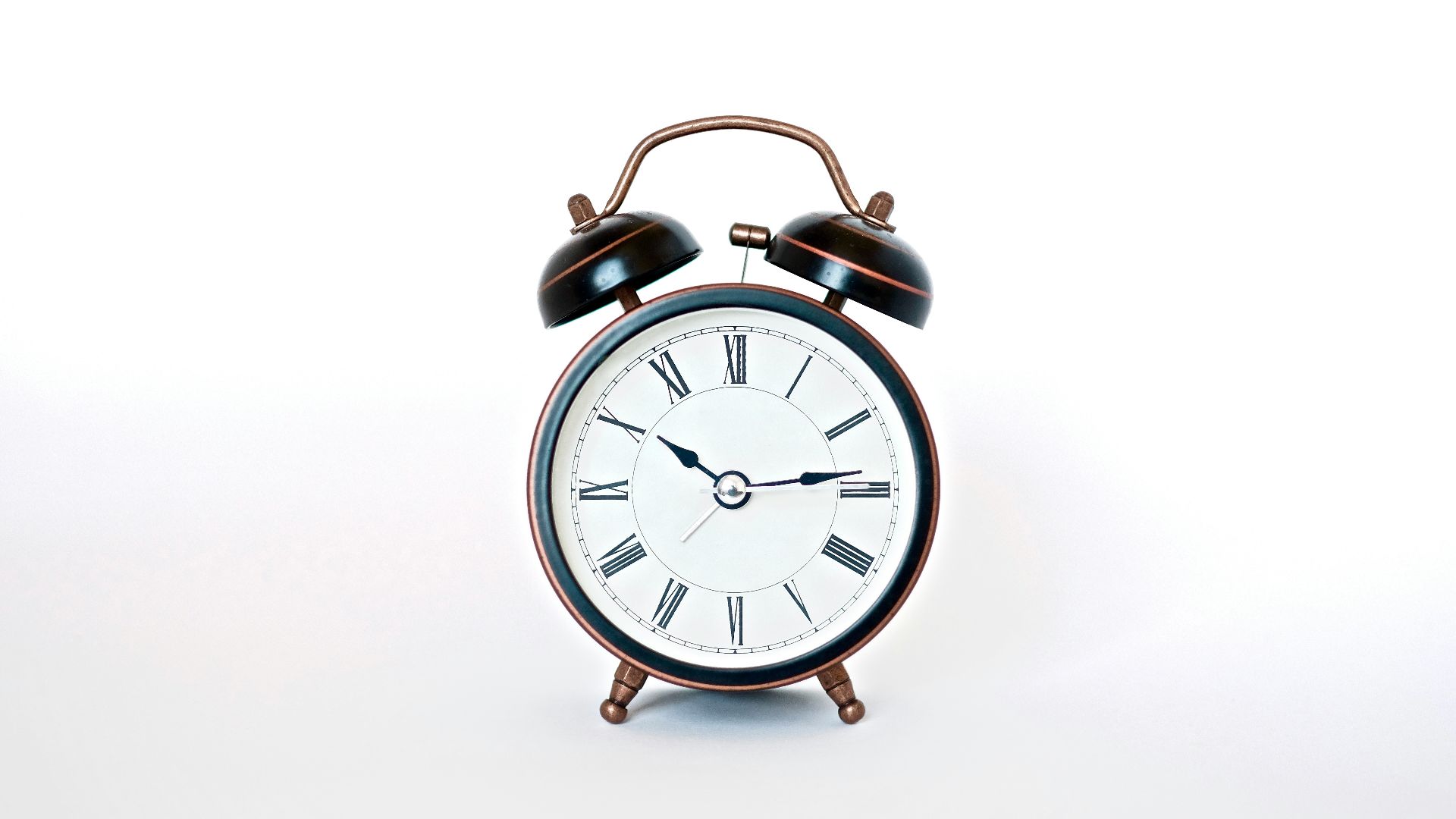 round black and white analog alarm clock