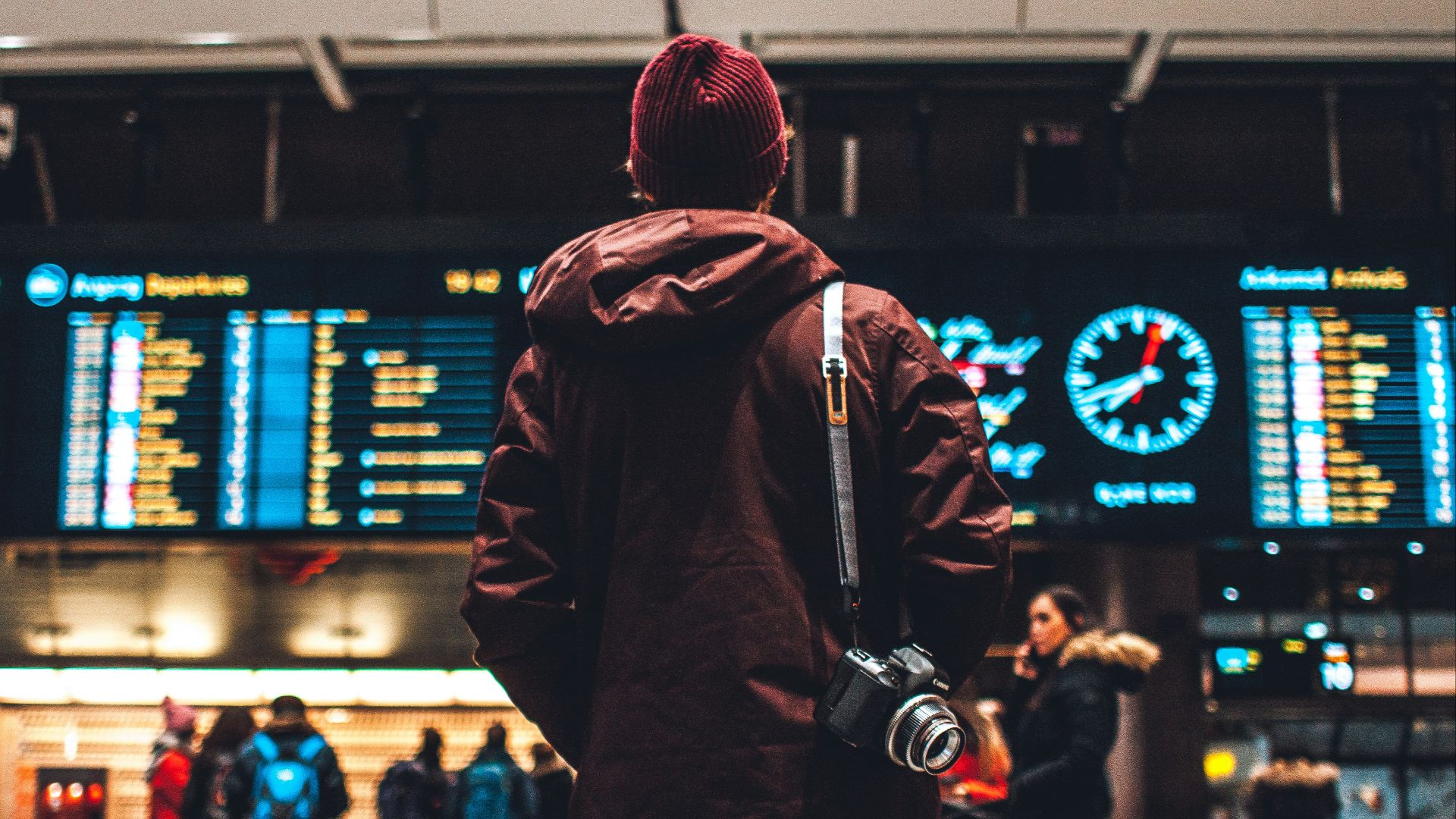 person looking up to the flight schedules