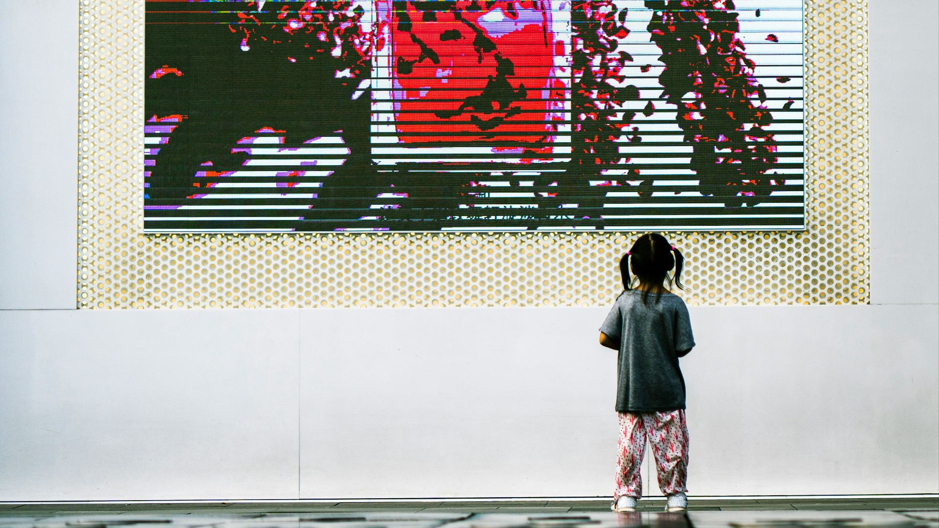 woman in black coat standing in front of graffiti wall