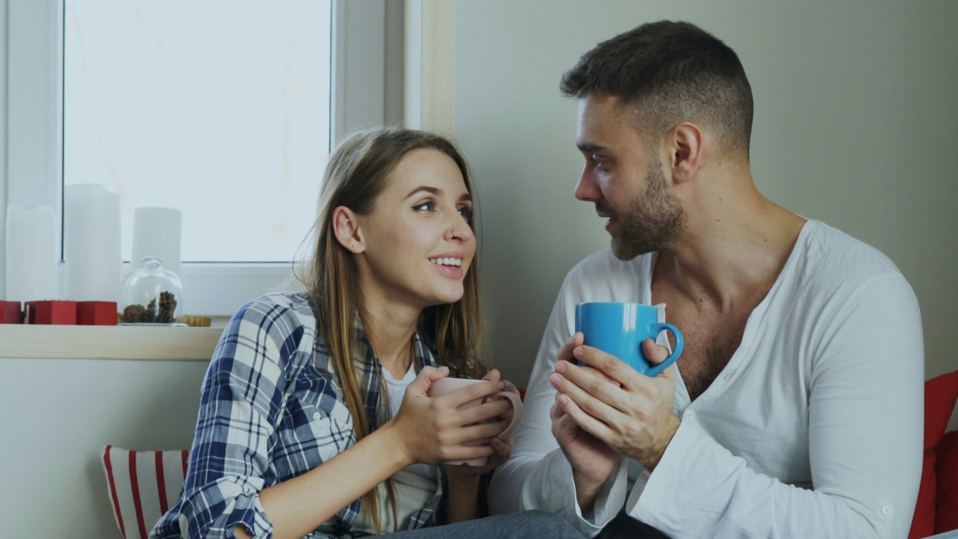 Couple enjoying drinks by the window