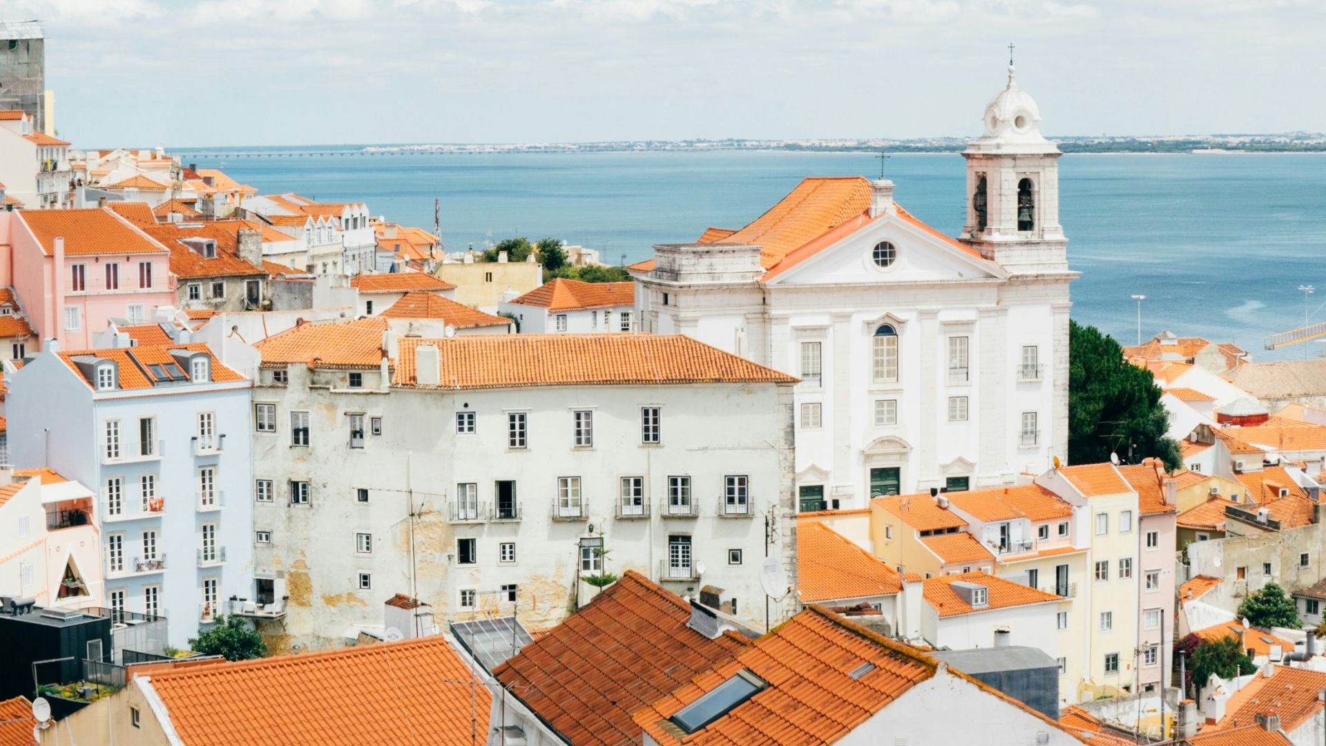 landscape photography of orange roof houses near body of water