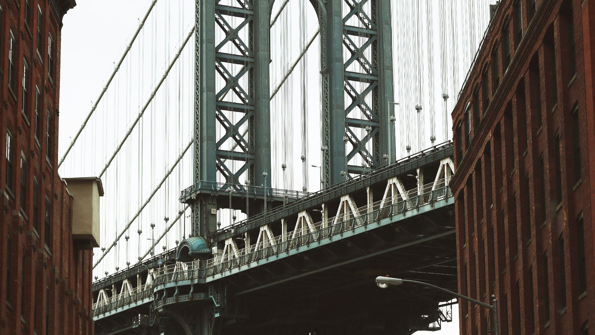 vehicles parked along the road near metal bridge