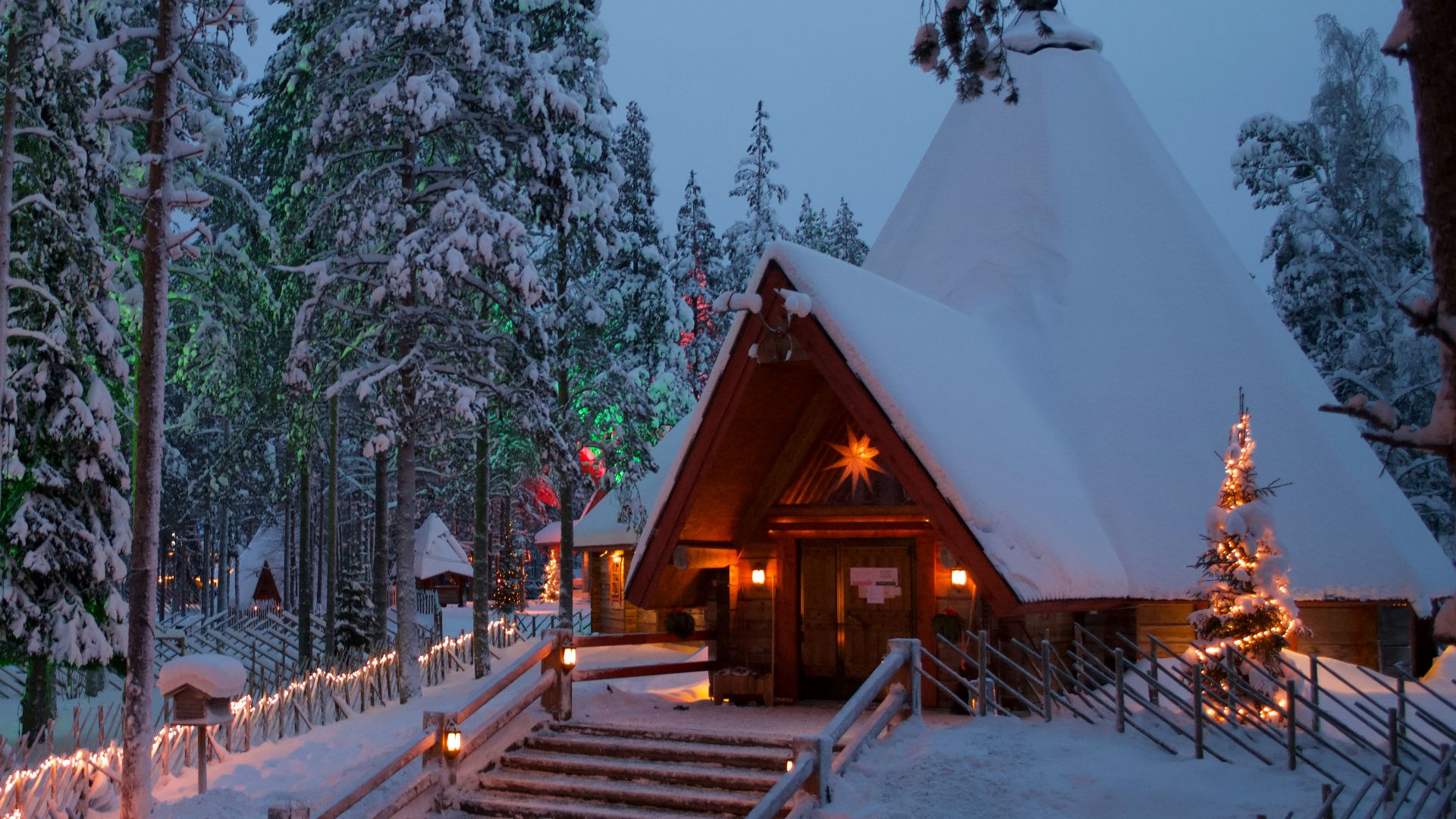 a cabin in the woods is lit up with christmas lights