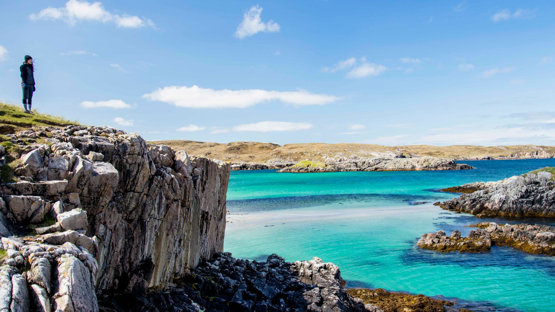 a person standing on a rocky cliff