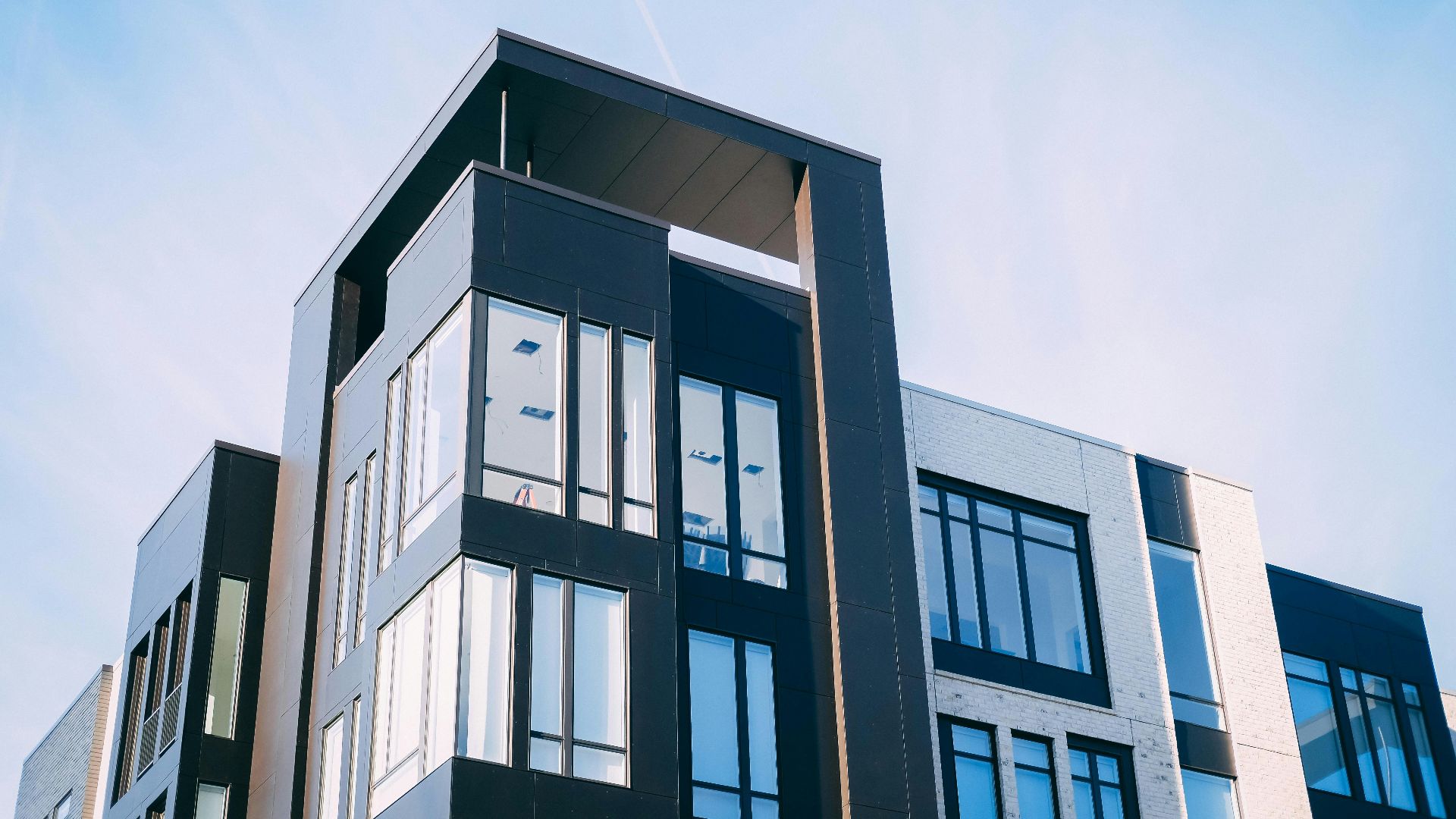 black and white cocnrete building low-angle photography