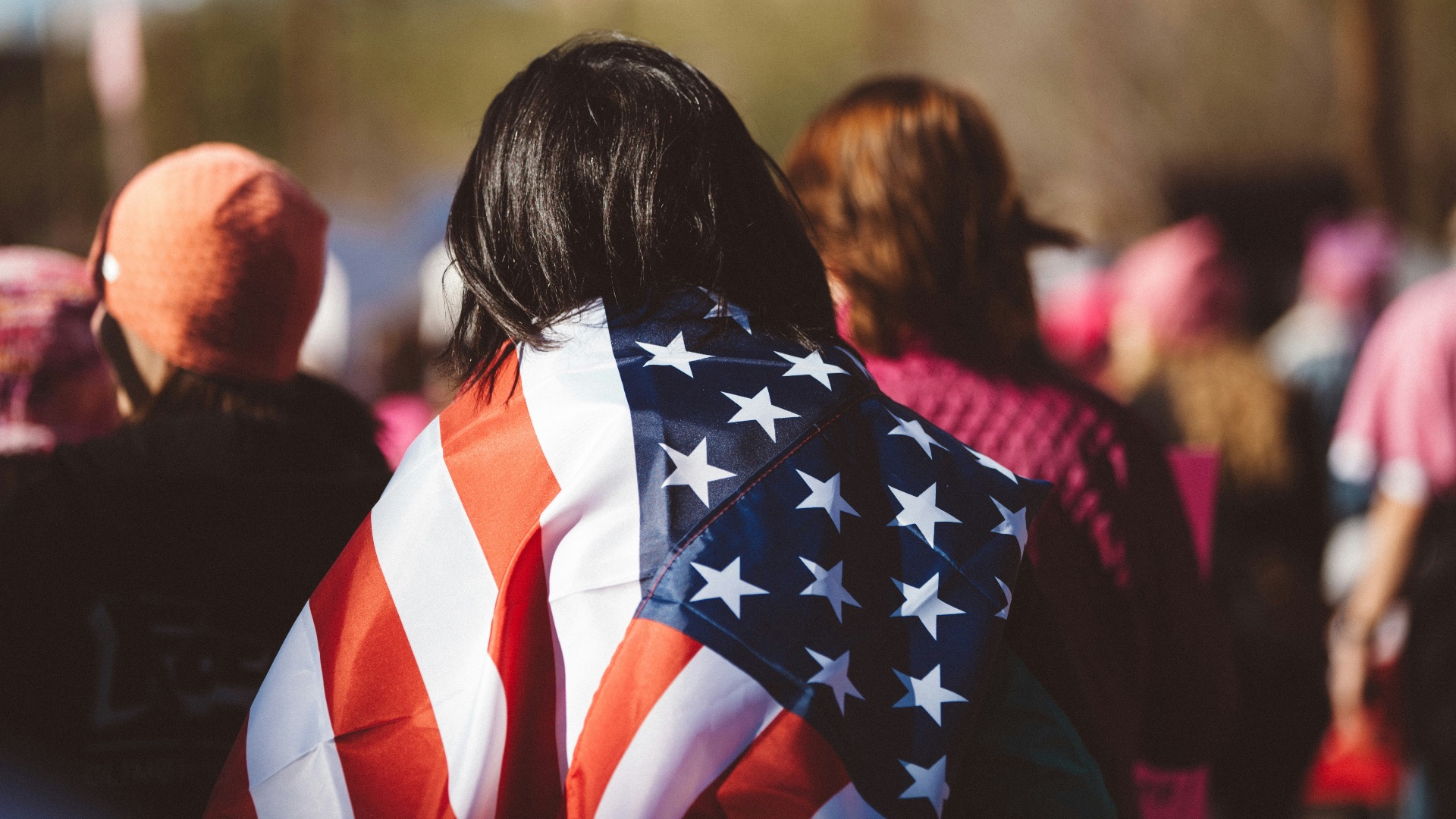 woman with US American flag on her shoulders