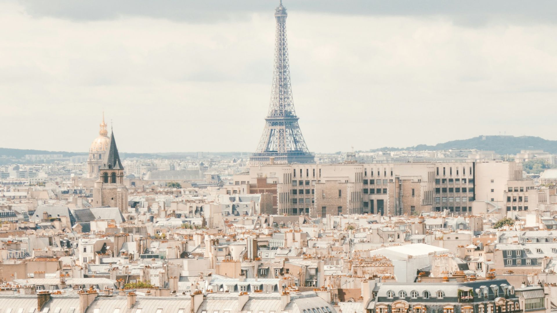 group of people walking near body of water and building under blue sky at daytime