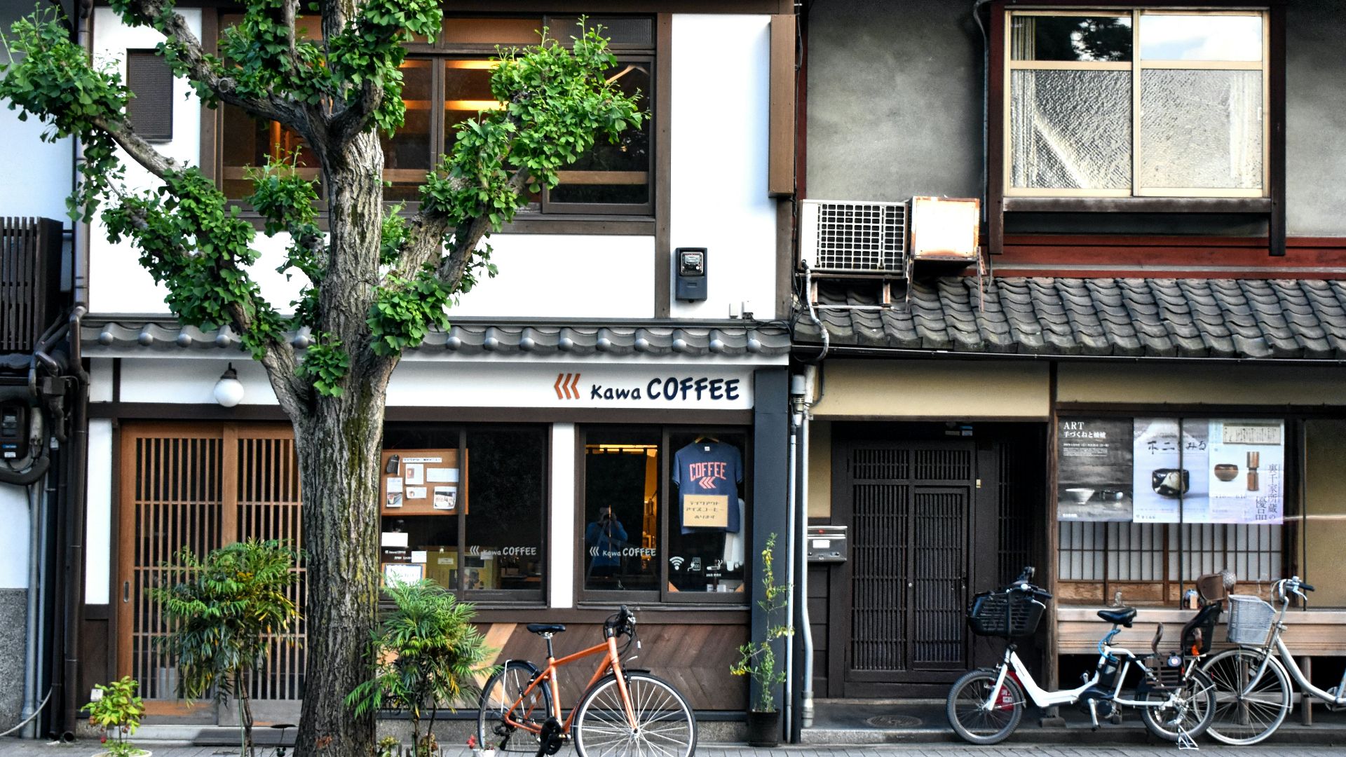 black bicycle parked beside brown and white concrete building during daytime