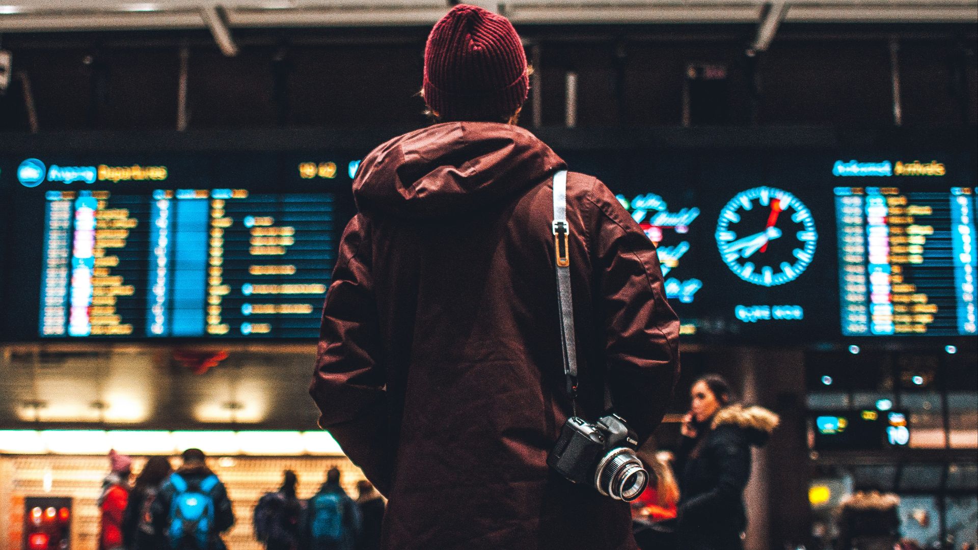 person looking up to the flight schedules