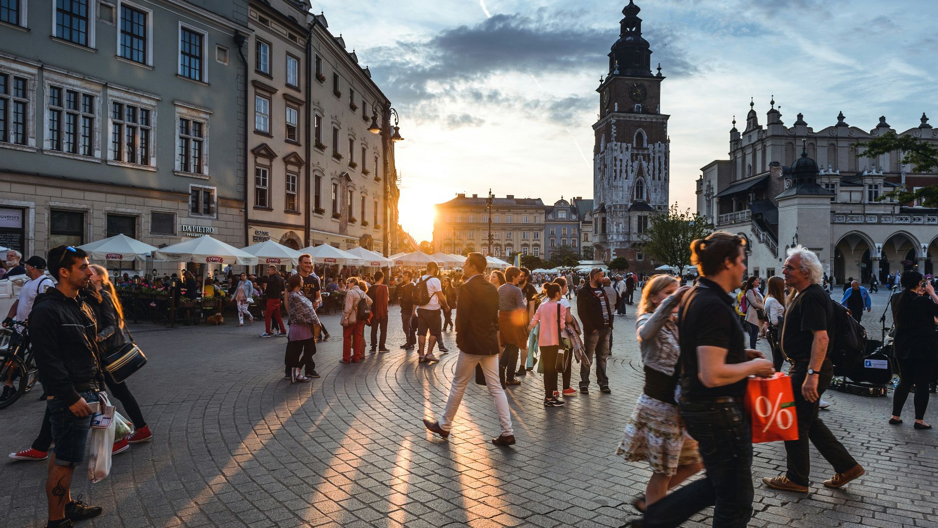 people walking on street near concrete buildings