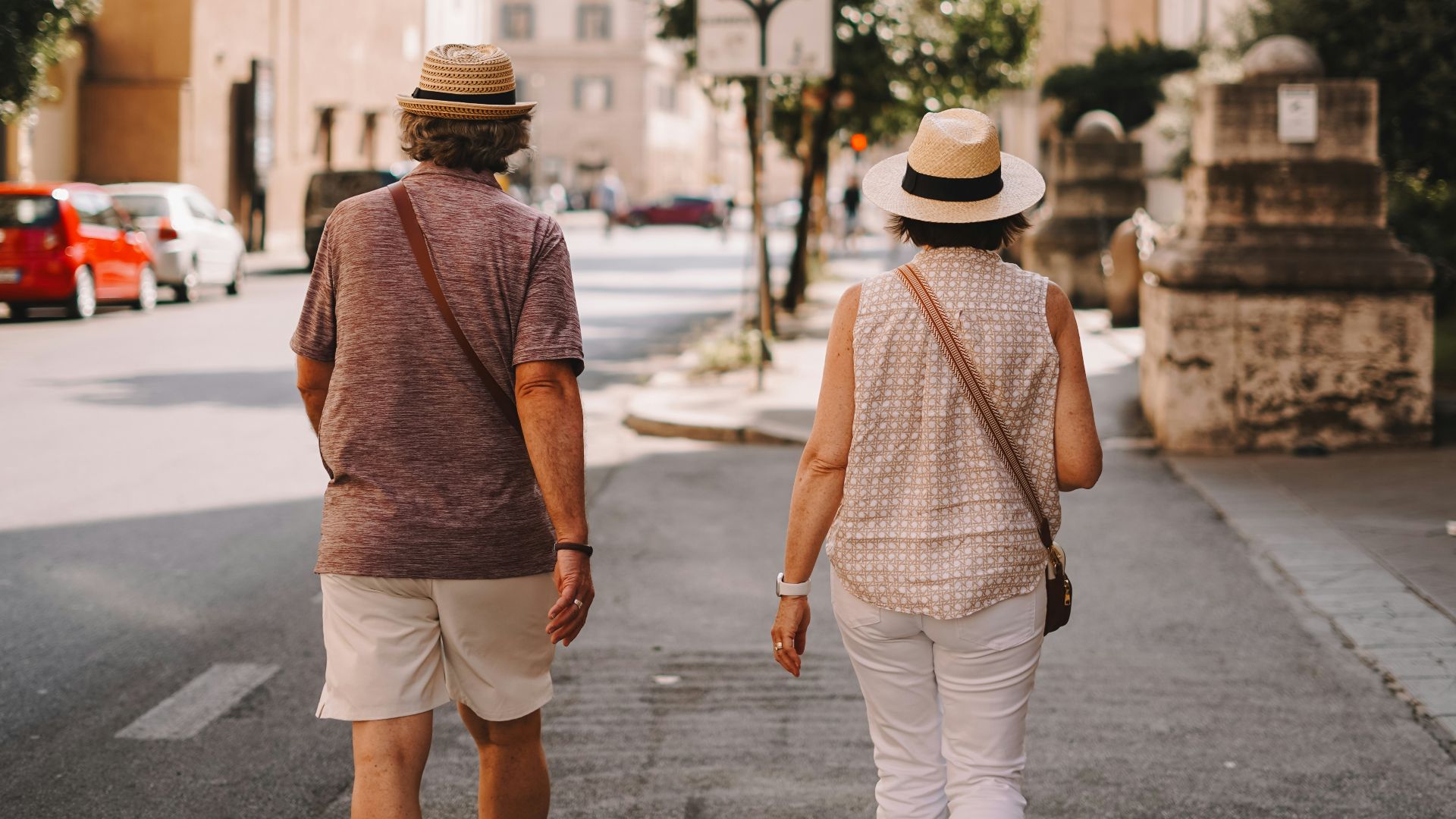 A man and a woman walking down a street