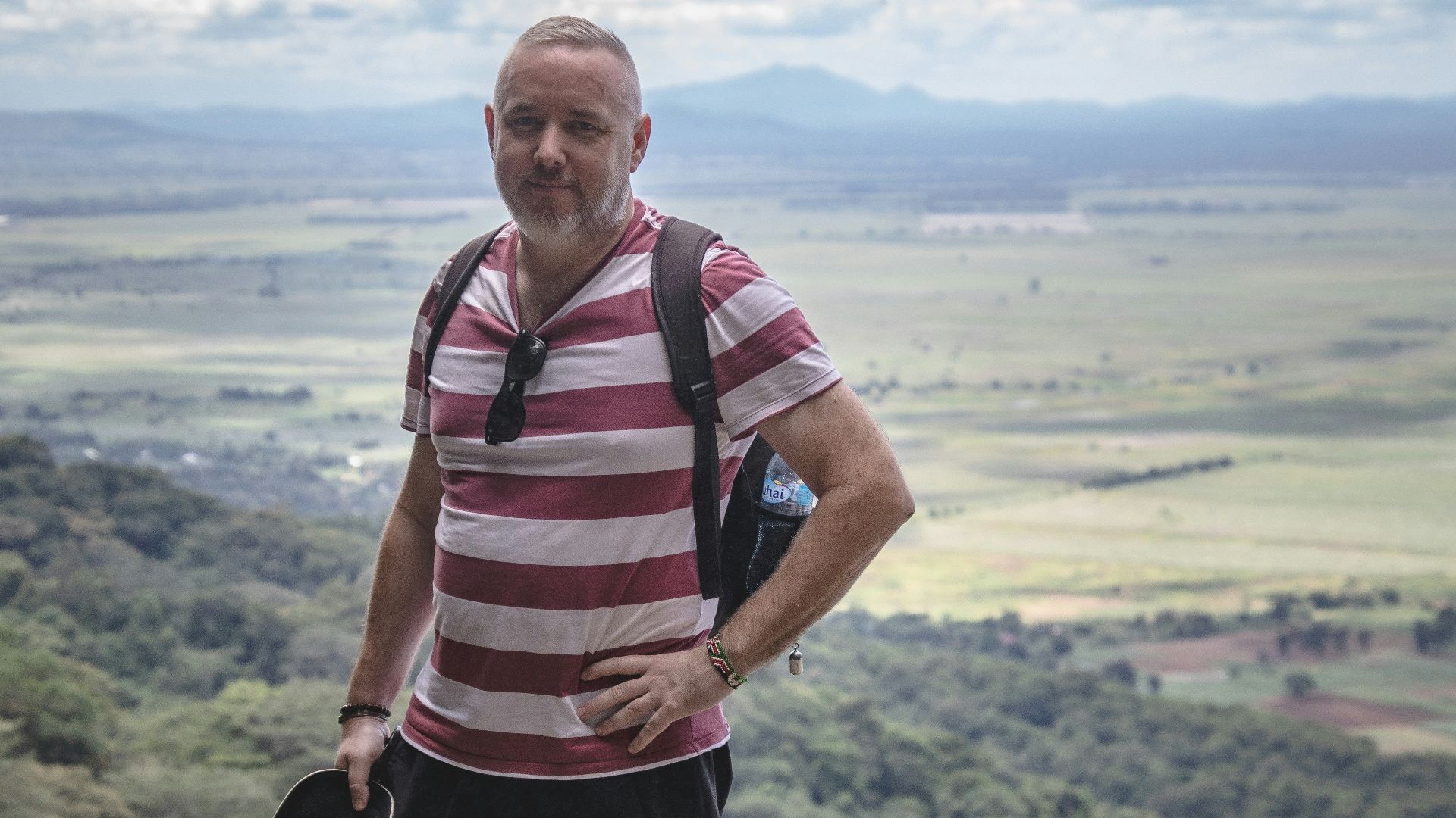 a man standing on top of a mountain with a backpack