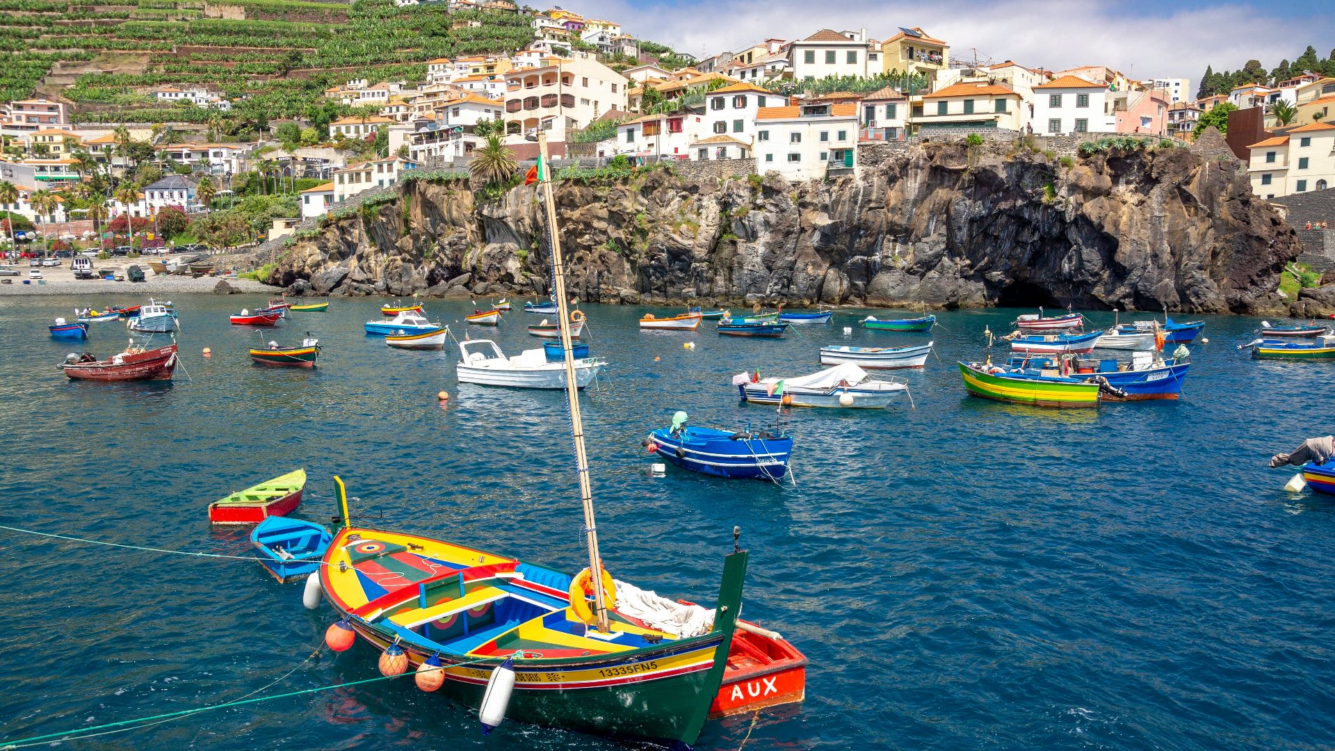 green and yellow boat on body of water during daytime