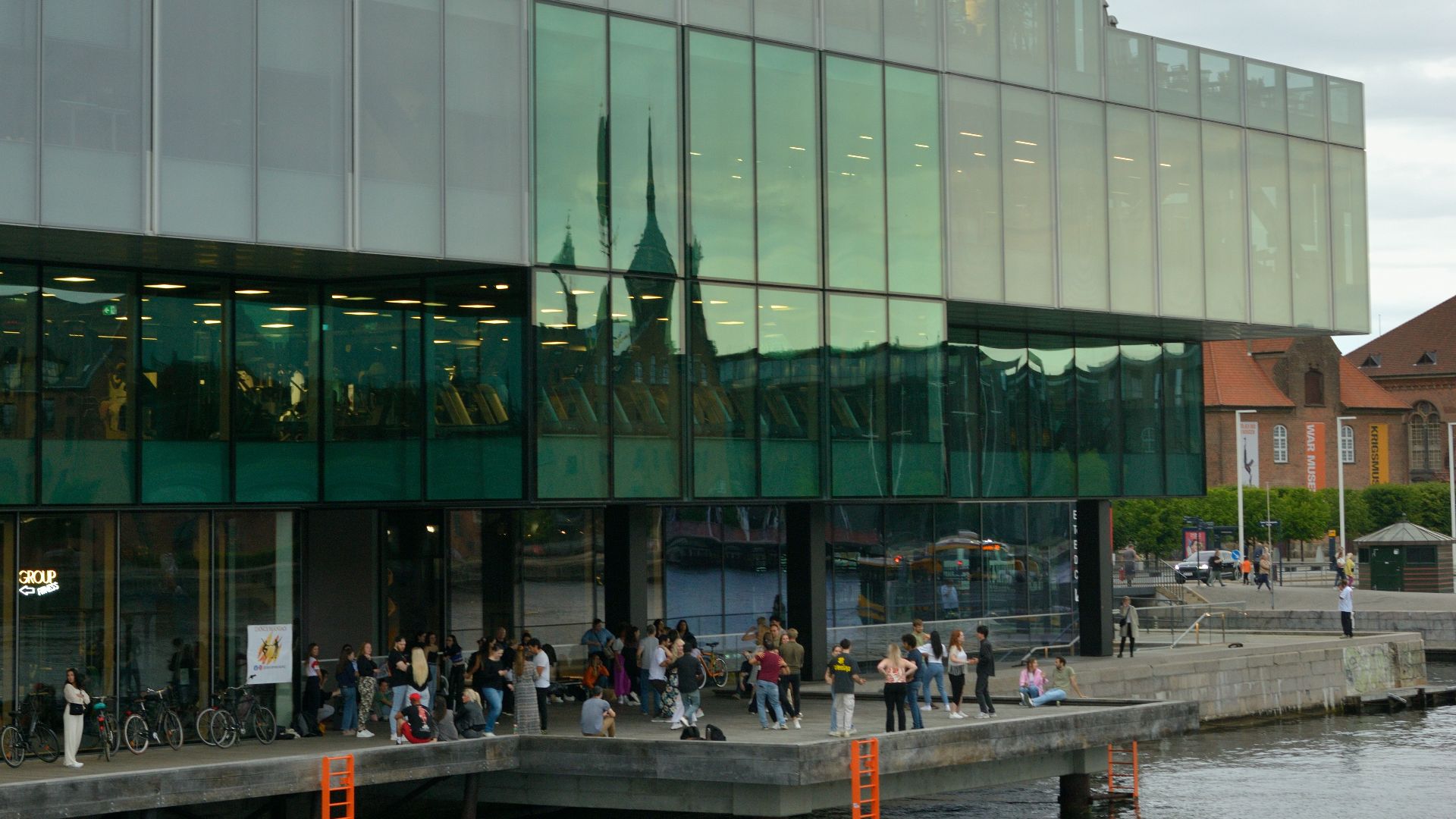 Modern building with glass facade overlooking water