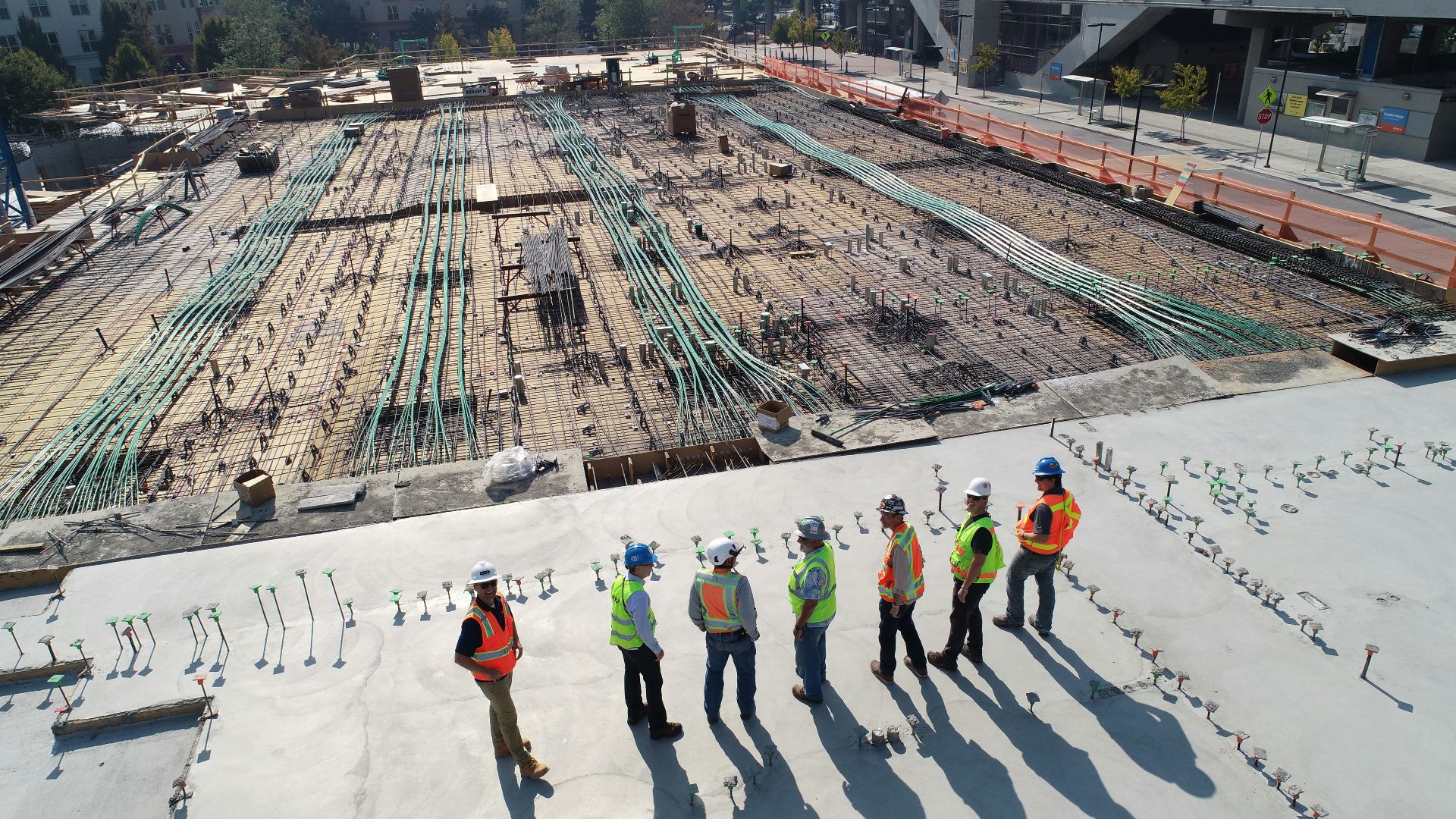 seven construction workers standing on white field