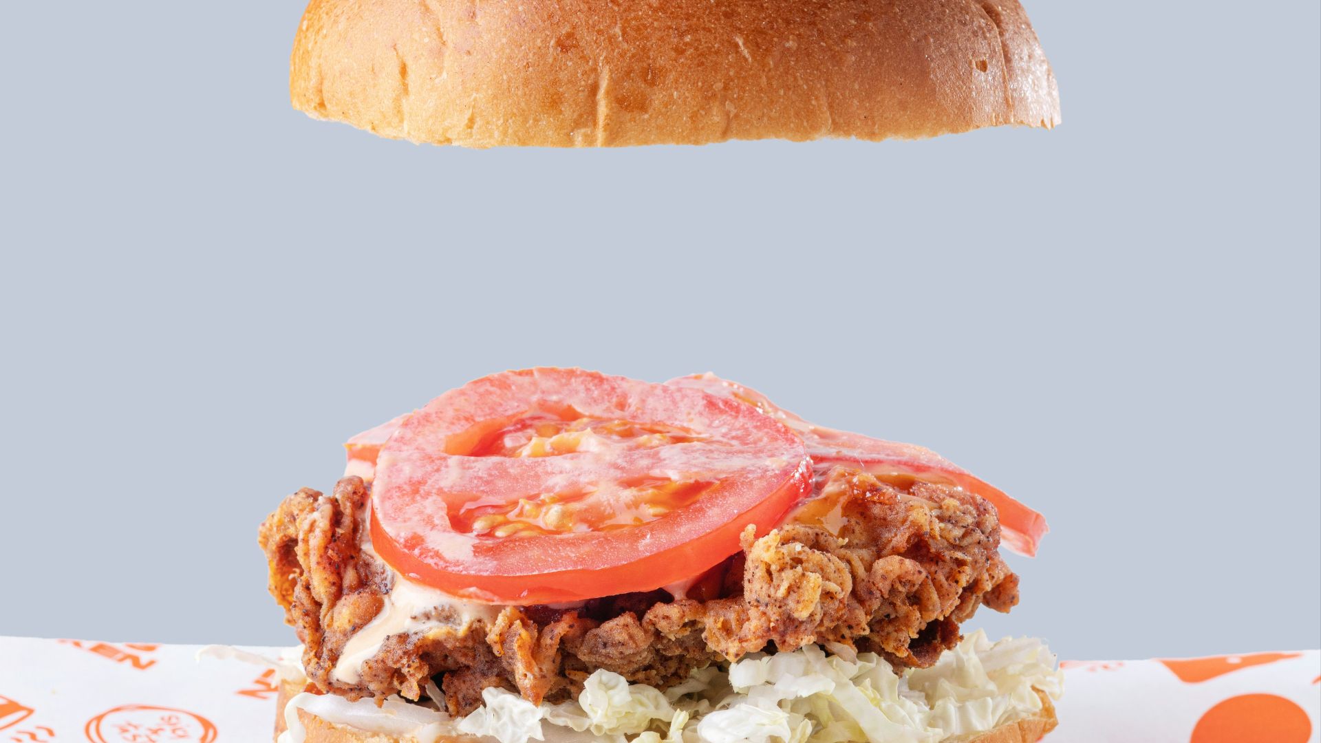 a sandwich with meat, tomato, and lettuce on a bun