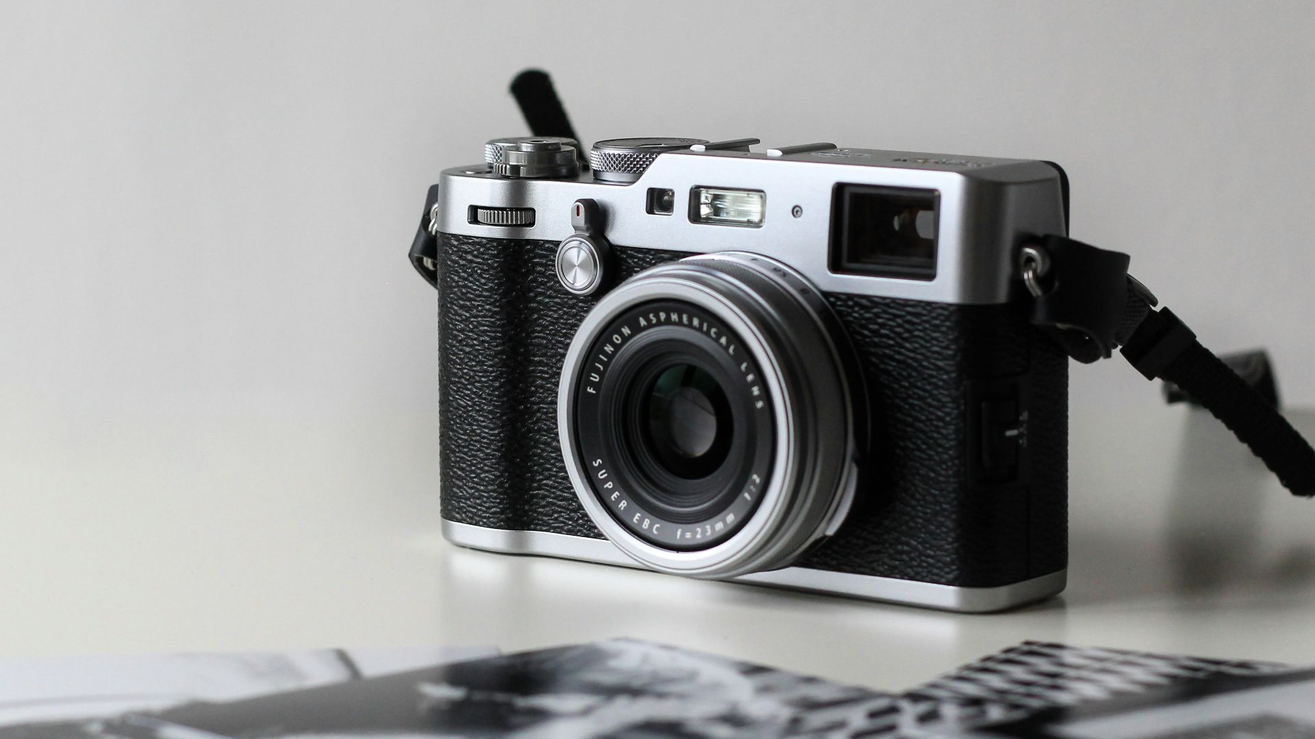 black and gray film camera near printed photos