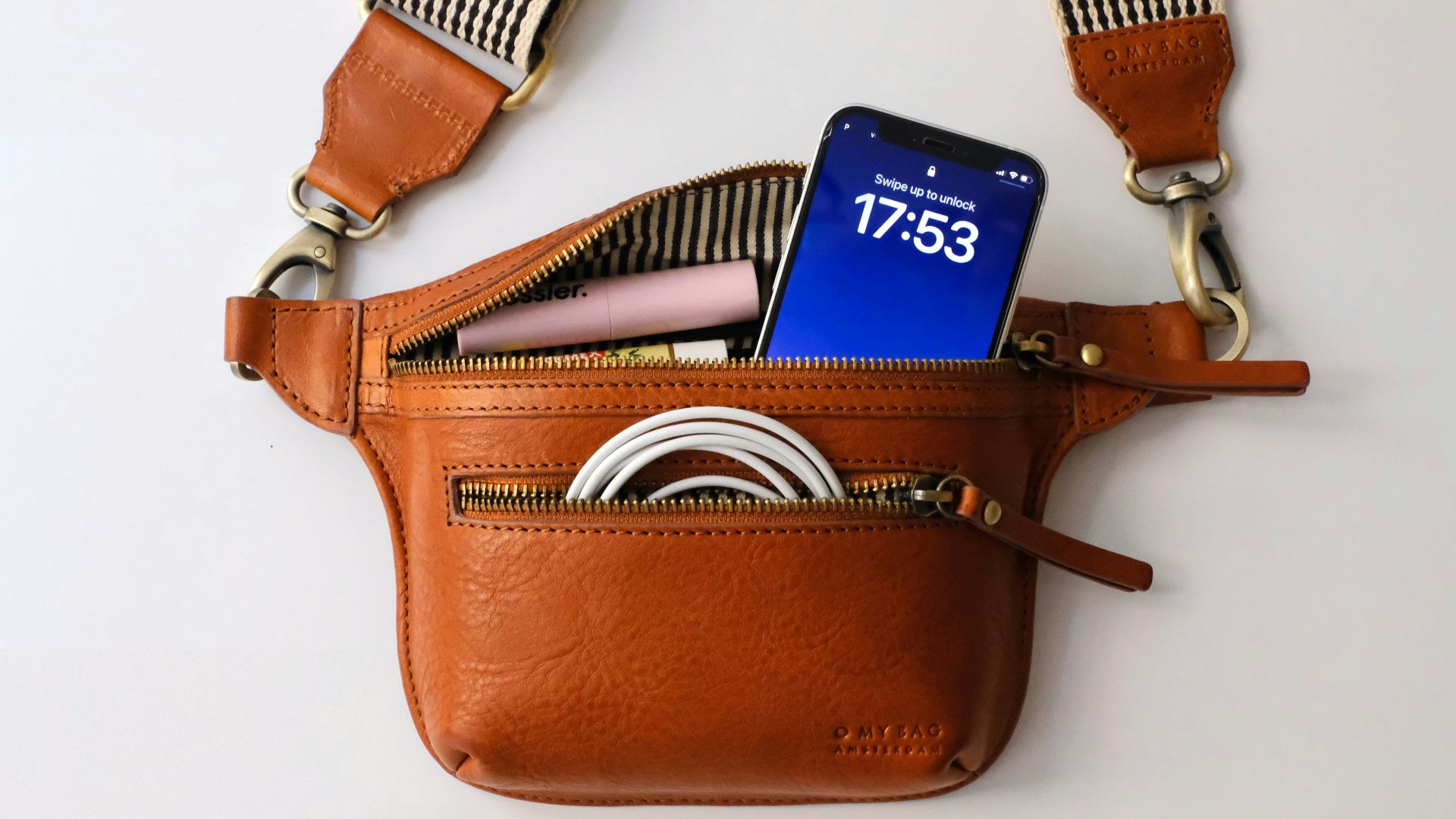 a brown purse with a blue tag