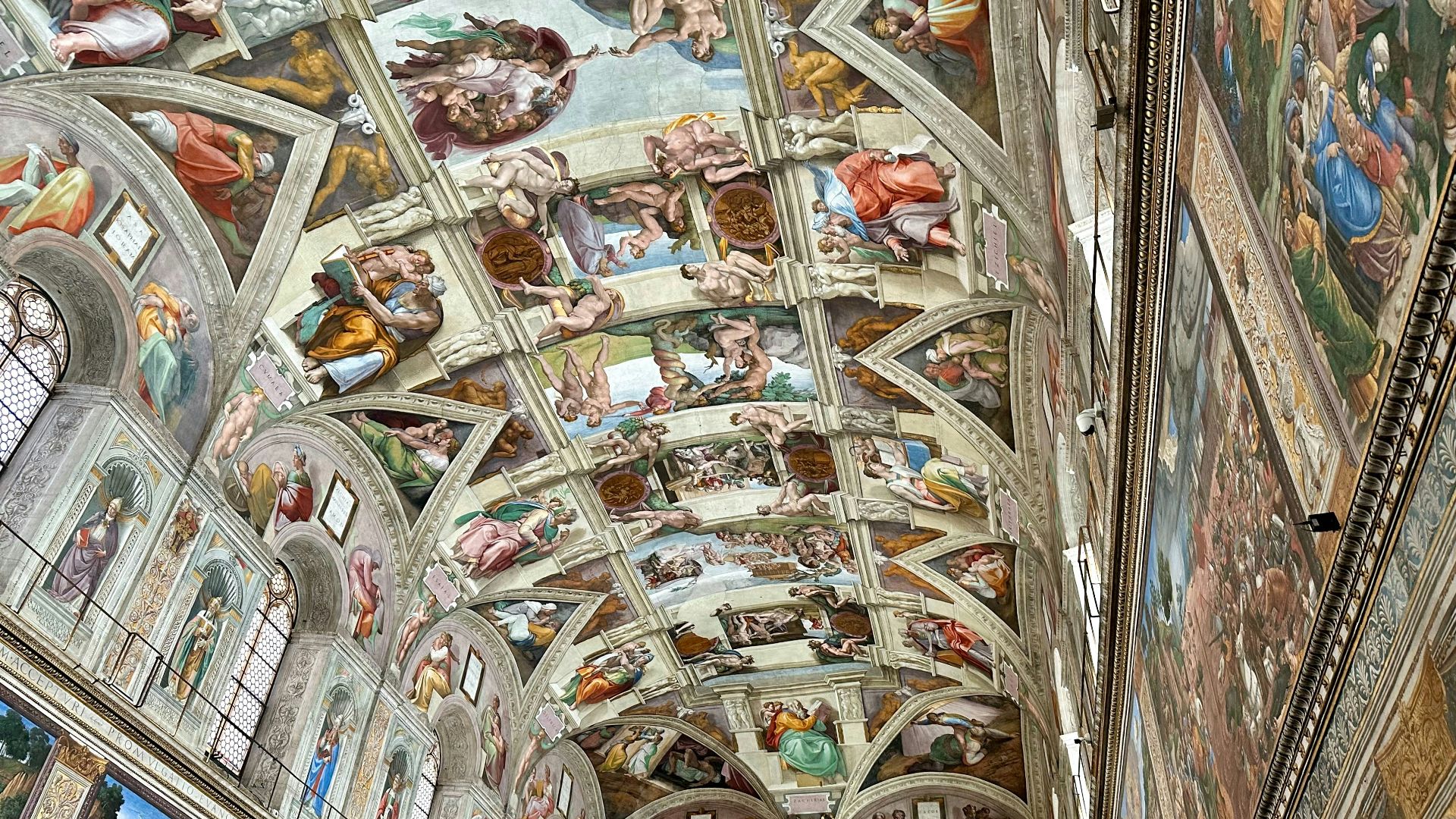 The ceiling of a building with many paintings on it