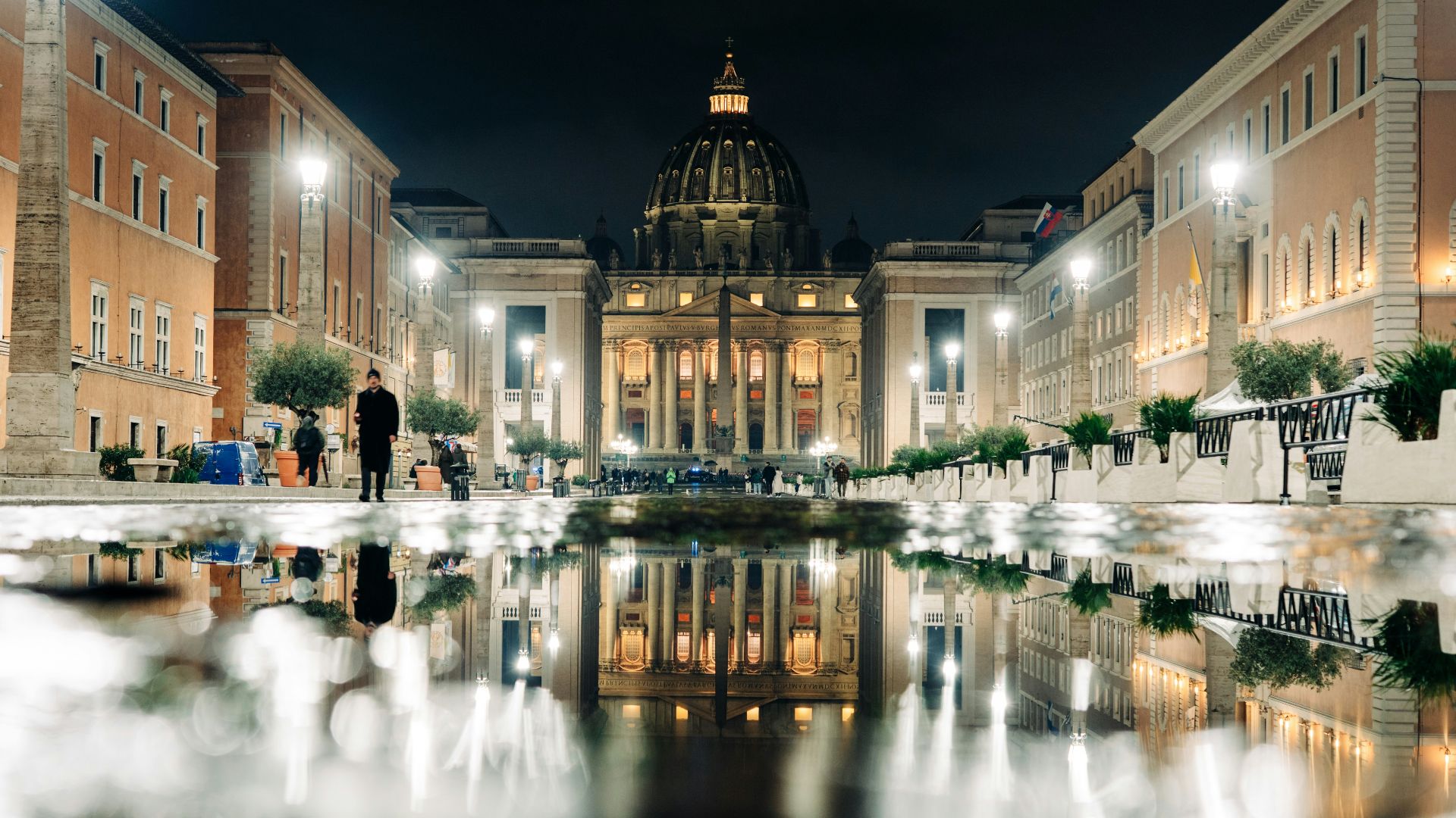 A reflection of a building in a pool of water