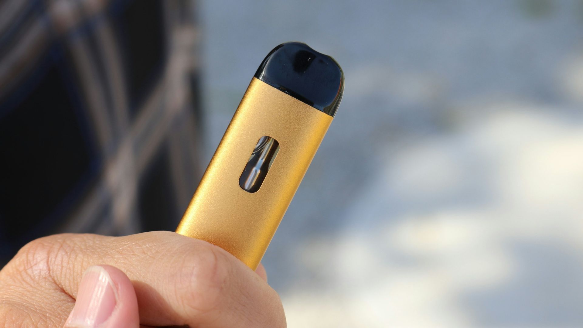 a person holding a yellow device