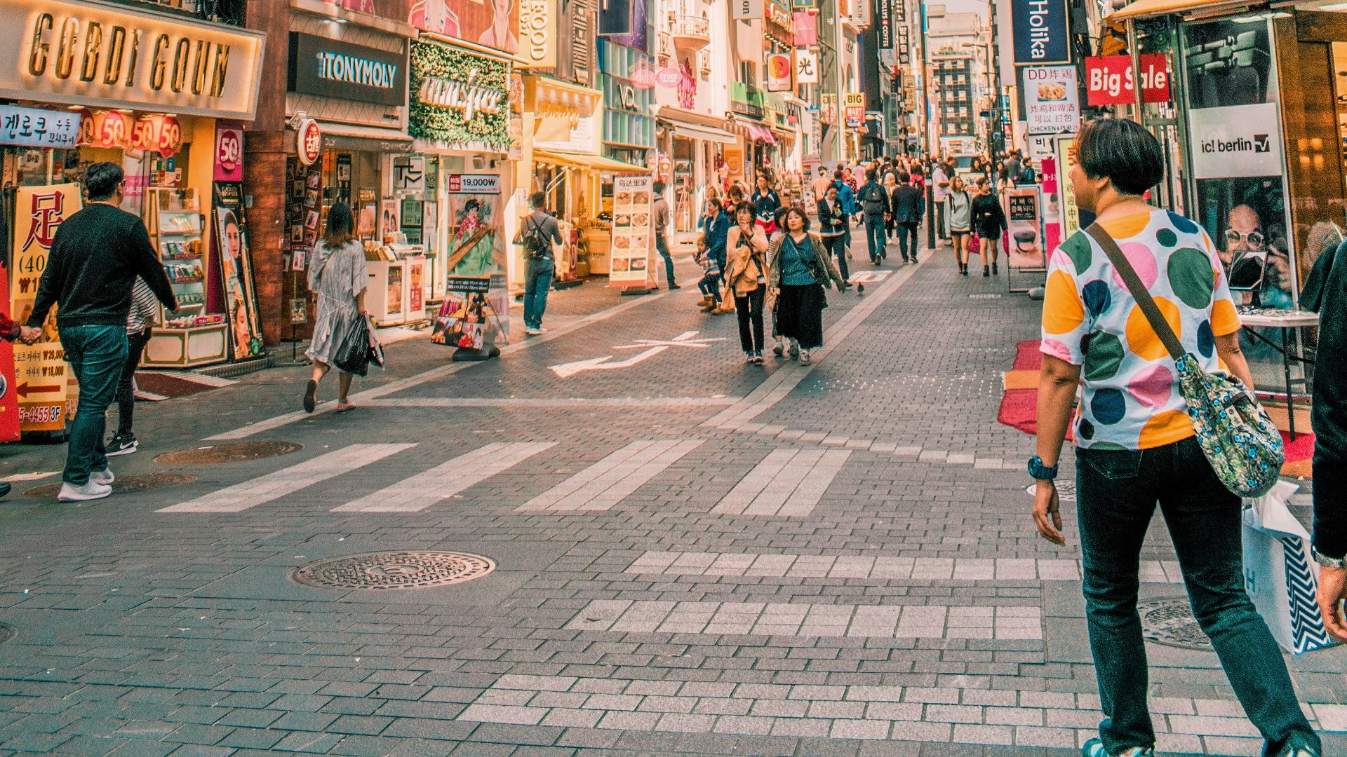 people walking on road surrounded by buildings