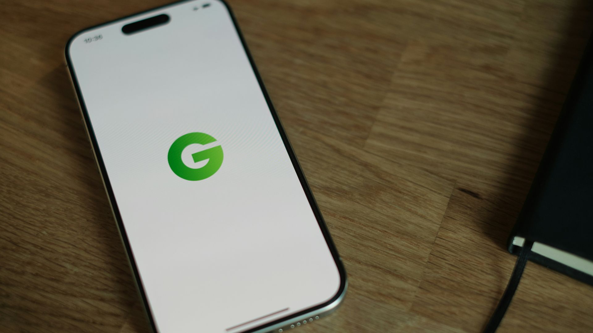 A cell phone sitting on top of a wooden table