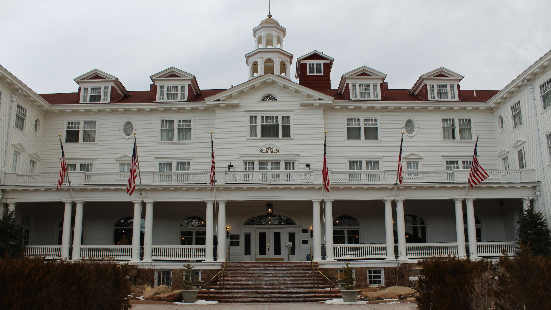 a large white building with a clock tower