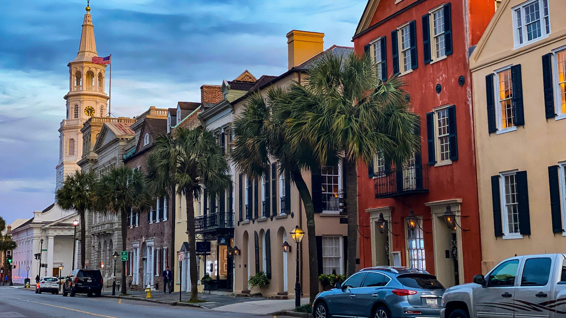 cars parked beside brown concrete building during daytime