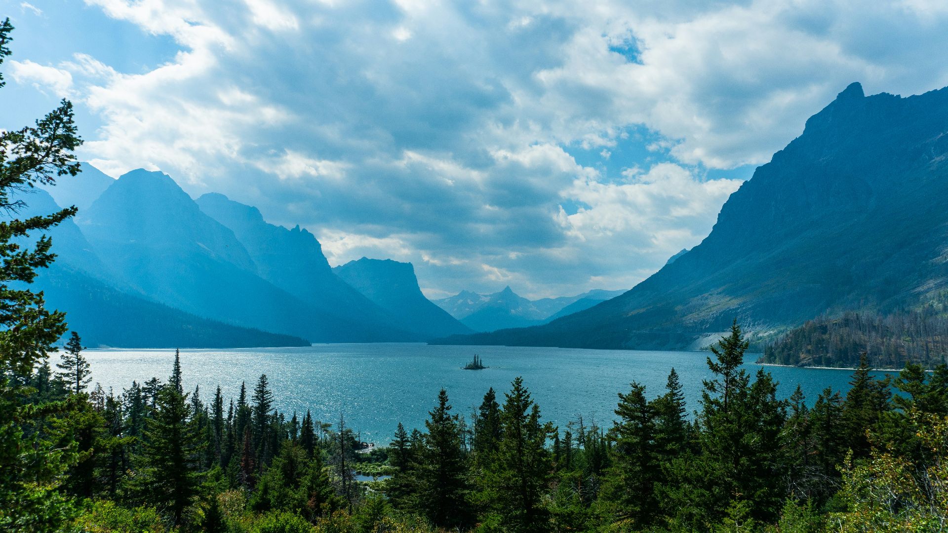 a scenic view of a lake surrounded by mountains