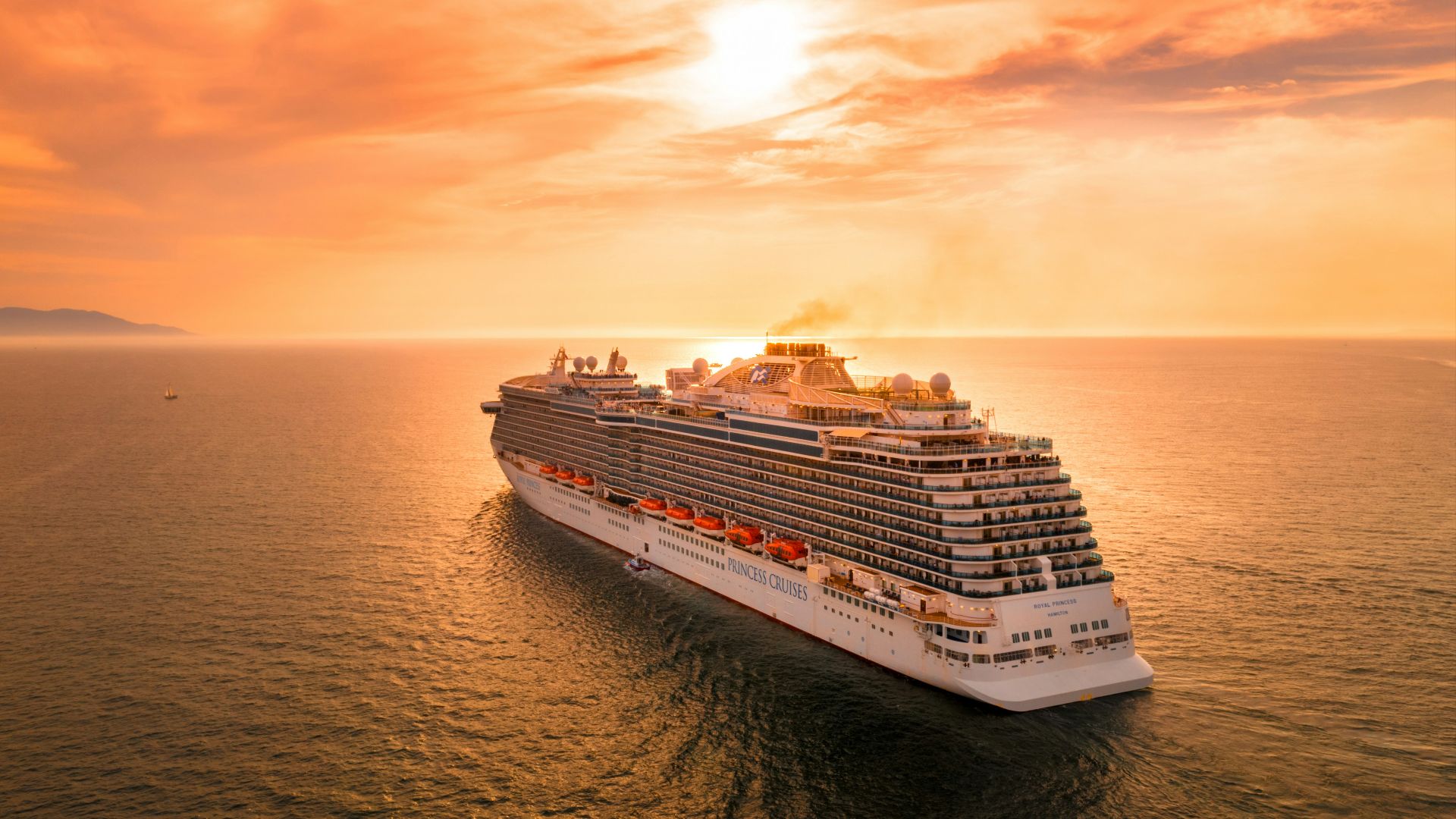 white ship on sea during sunset