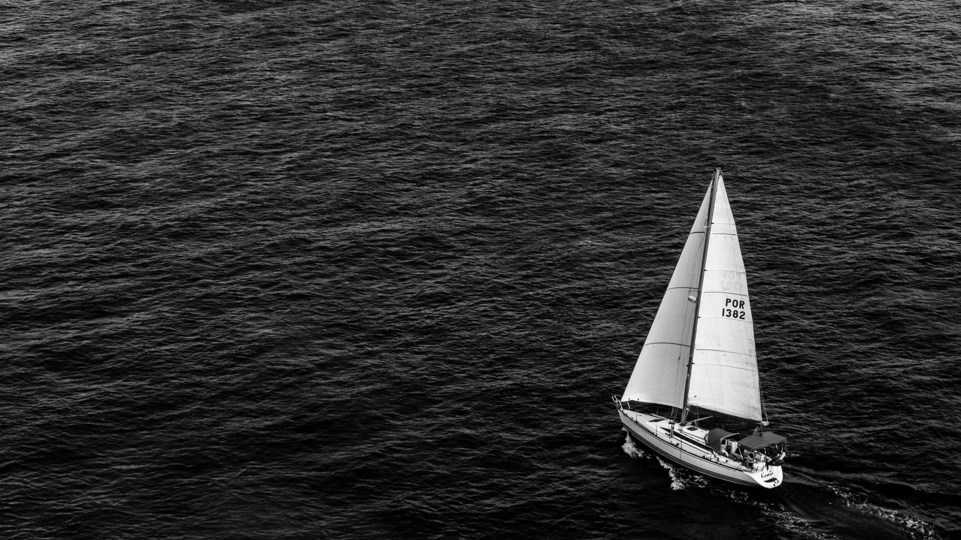grayscale photography of sailing boat on body of water